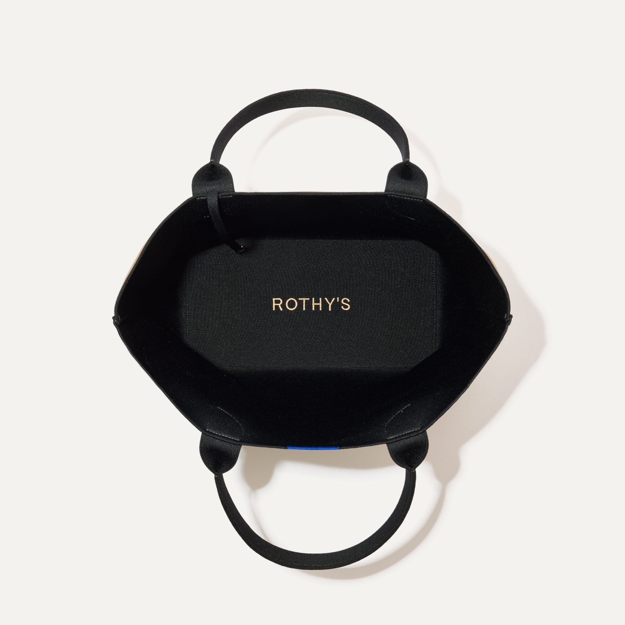 The Lightweight Tote in Shortbread shown open from the top, with interior visible. 