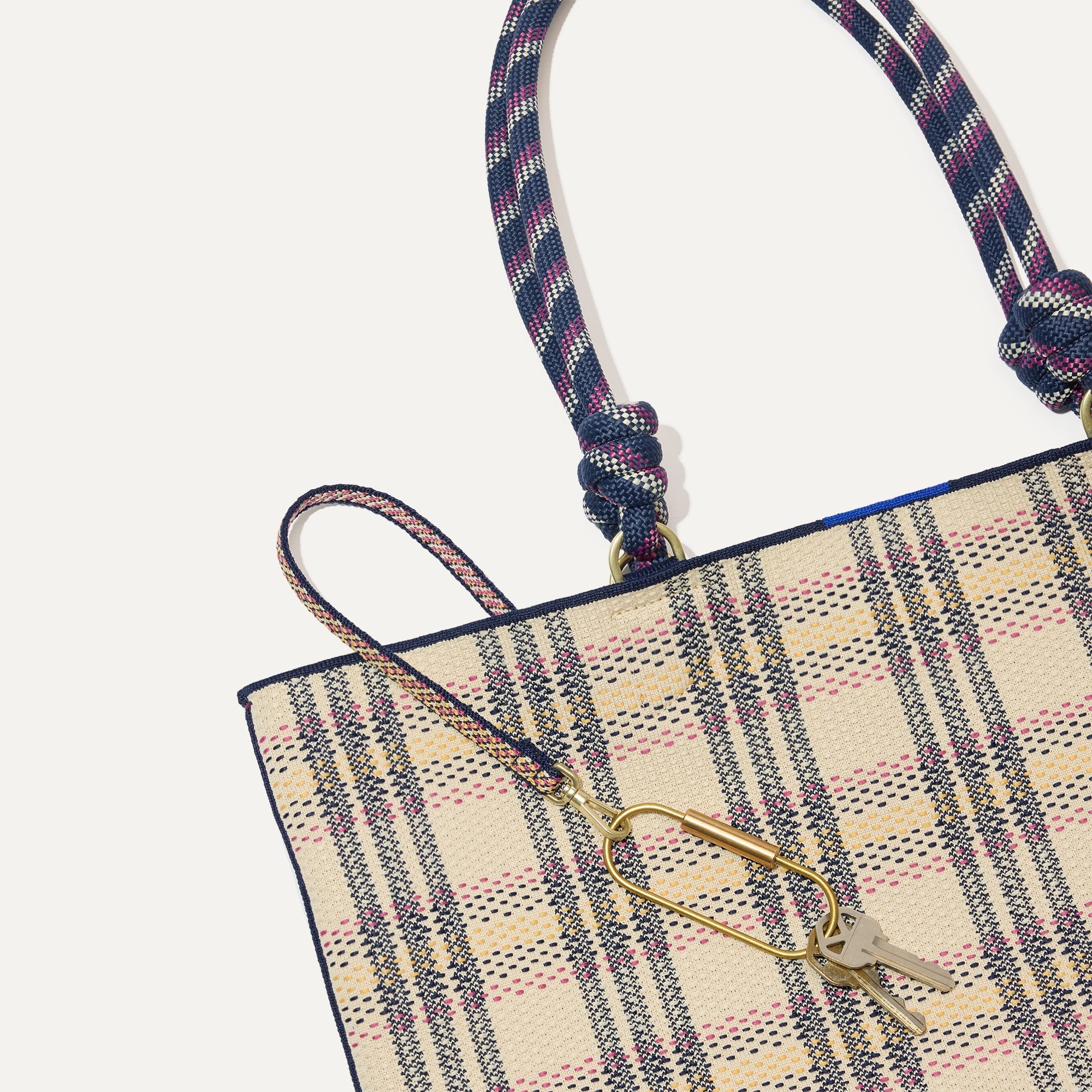 Close up of the handles and key leash detail of The Lightweight Tote in Spring Plaid.