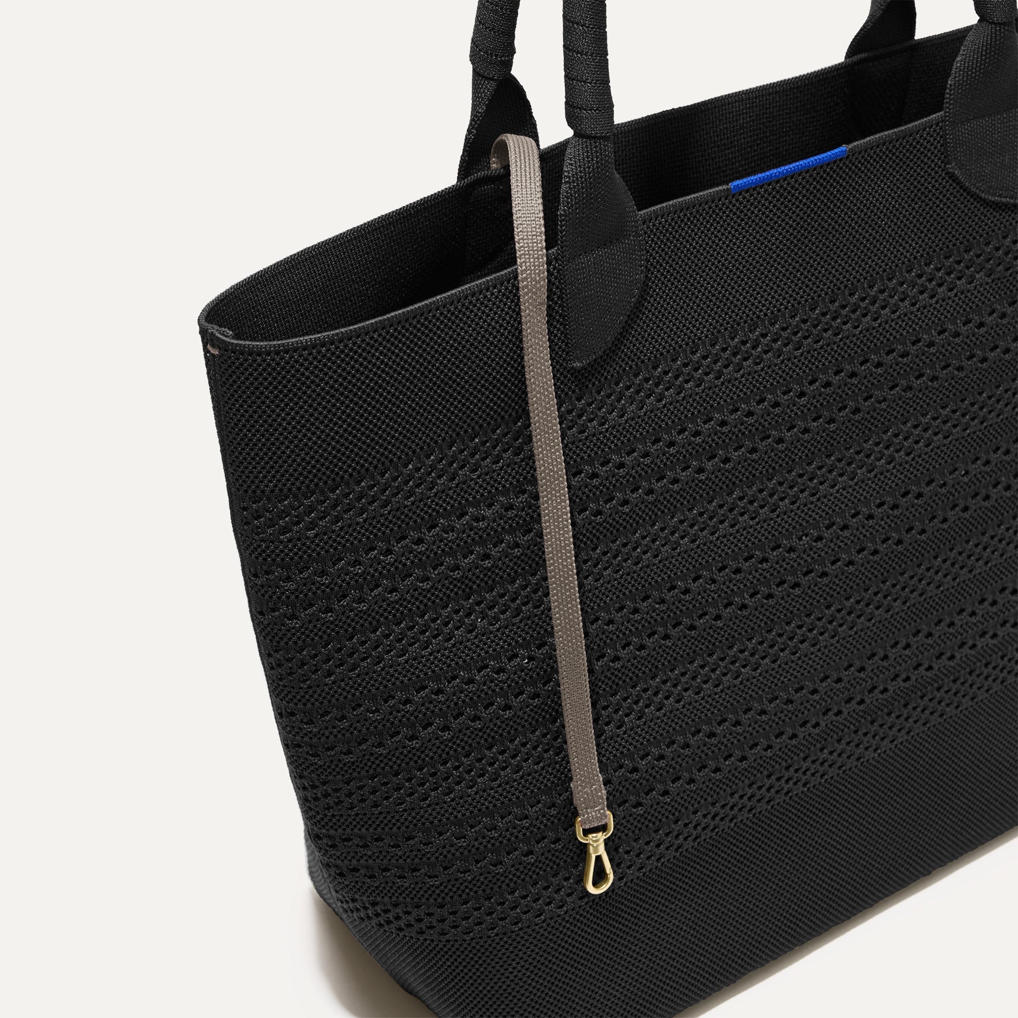 The Lightweight Tote in Black Crochet shown with its handy key leash.