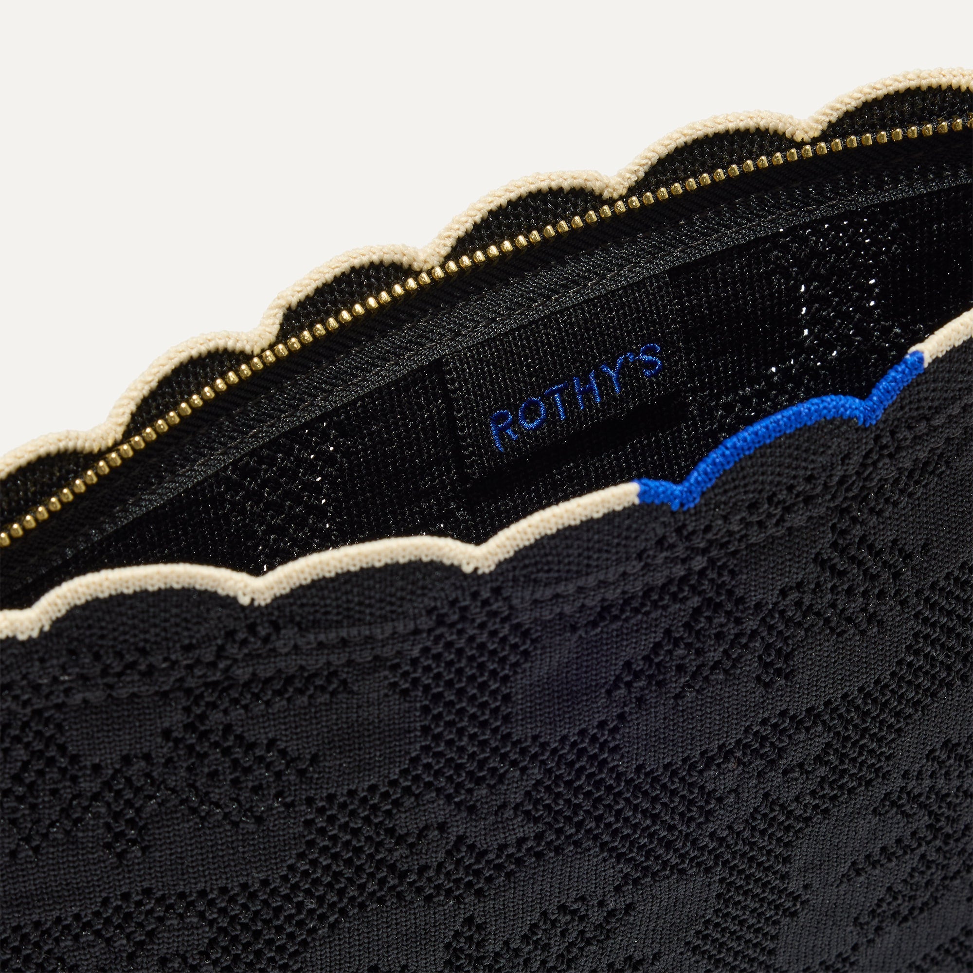 The Wristlet in Black Carnation interior view with Rothy's halo detail.