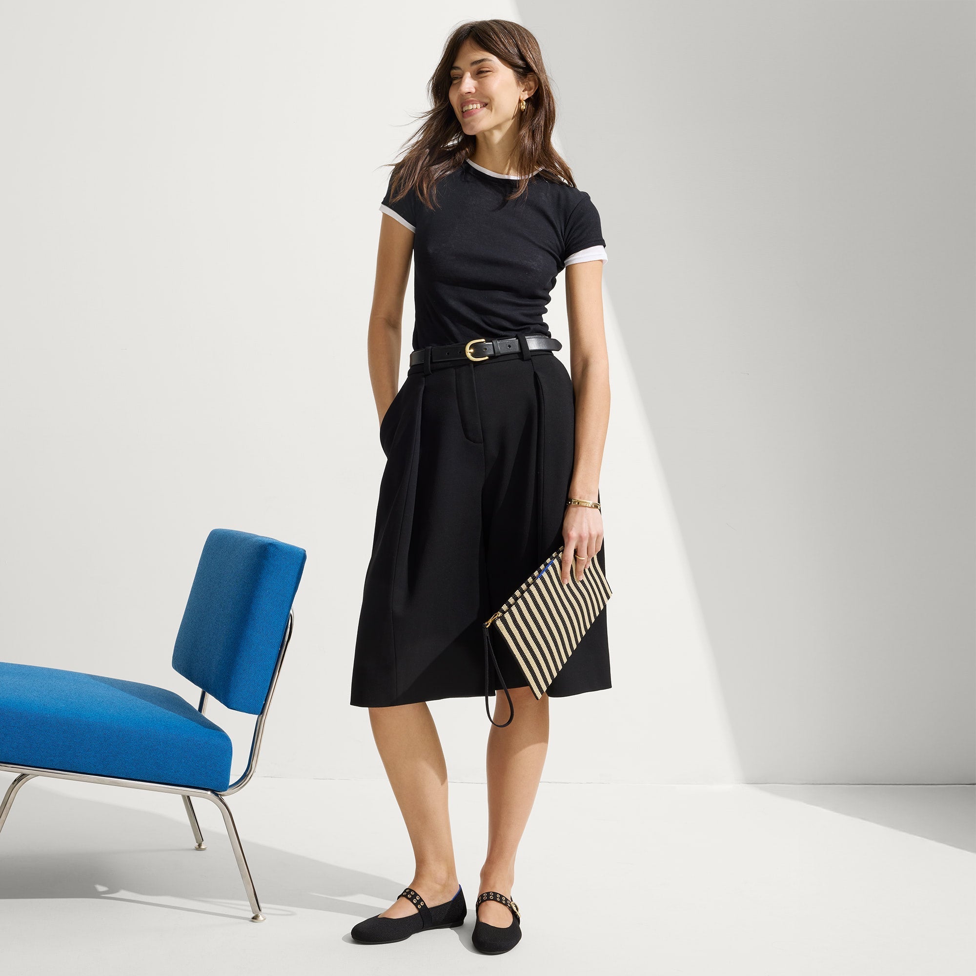 hover | The Wristlet in Black Tie held by a model shown from the front.