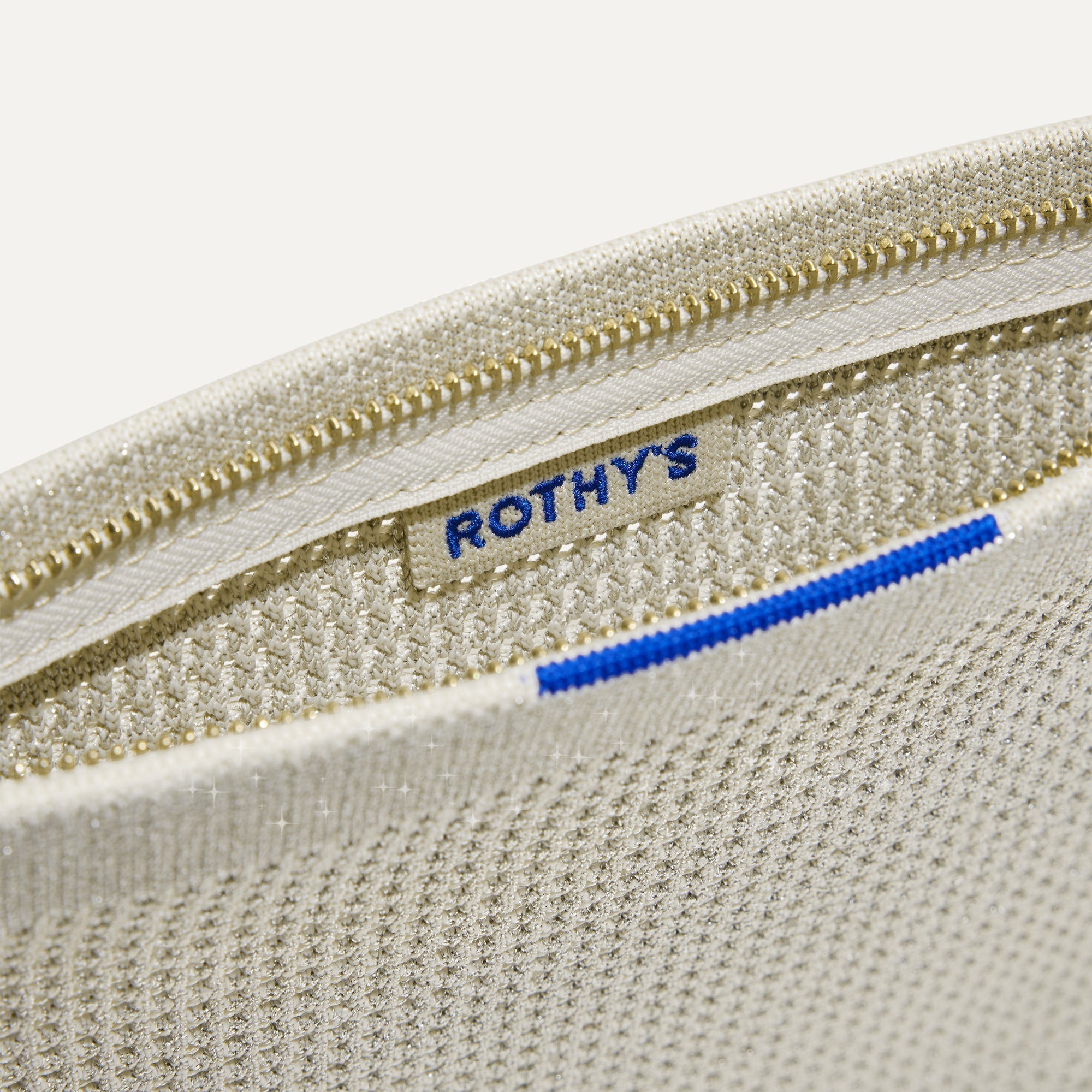 A closeup of The Wallet Wristlet in Diamond Metallic, focusing on the inner card slip.