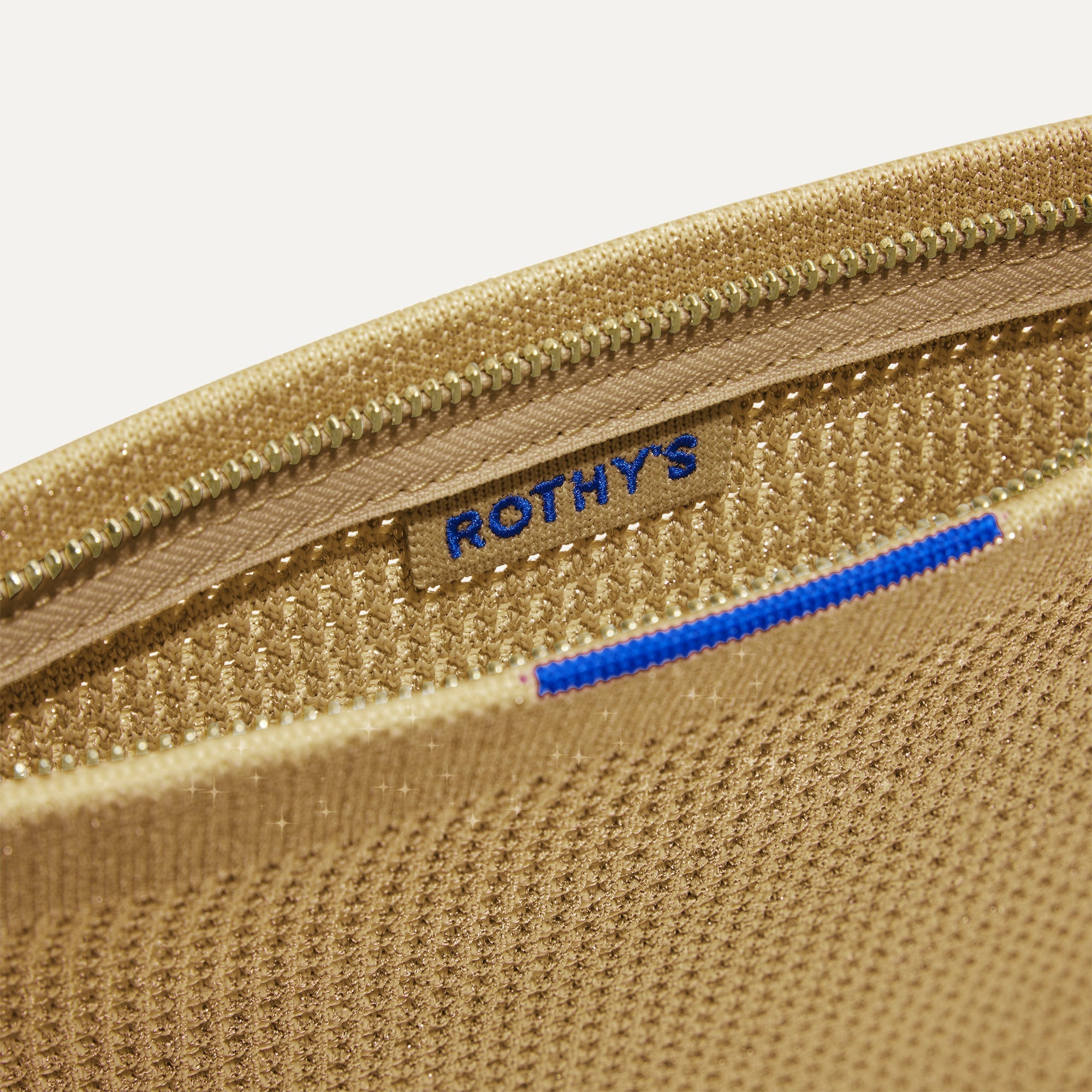 The Wristlet in Golden Perf interior view with Rothy's halo detail.