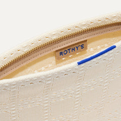 A closeup of The Wristlet in Ivory Perf, focusing on the inner card slip.