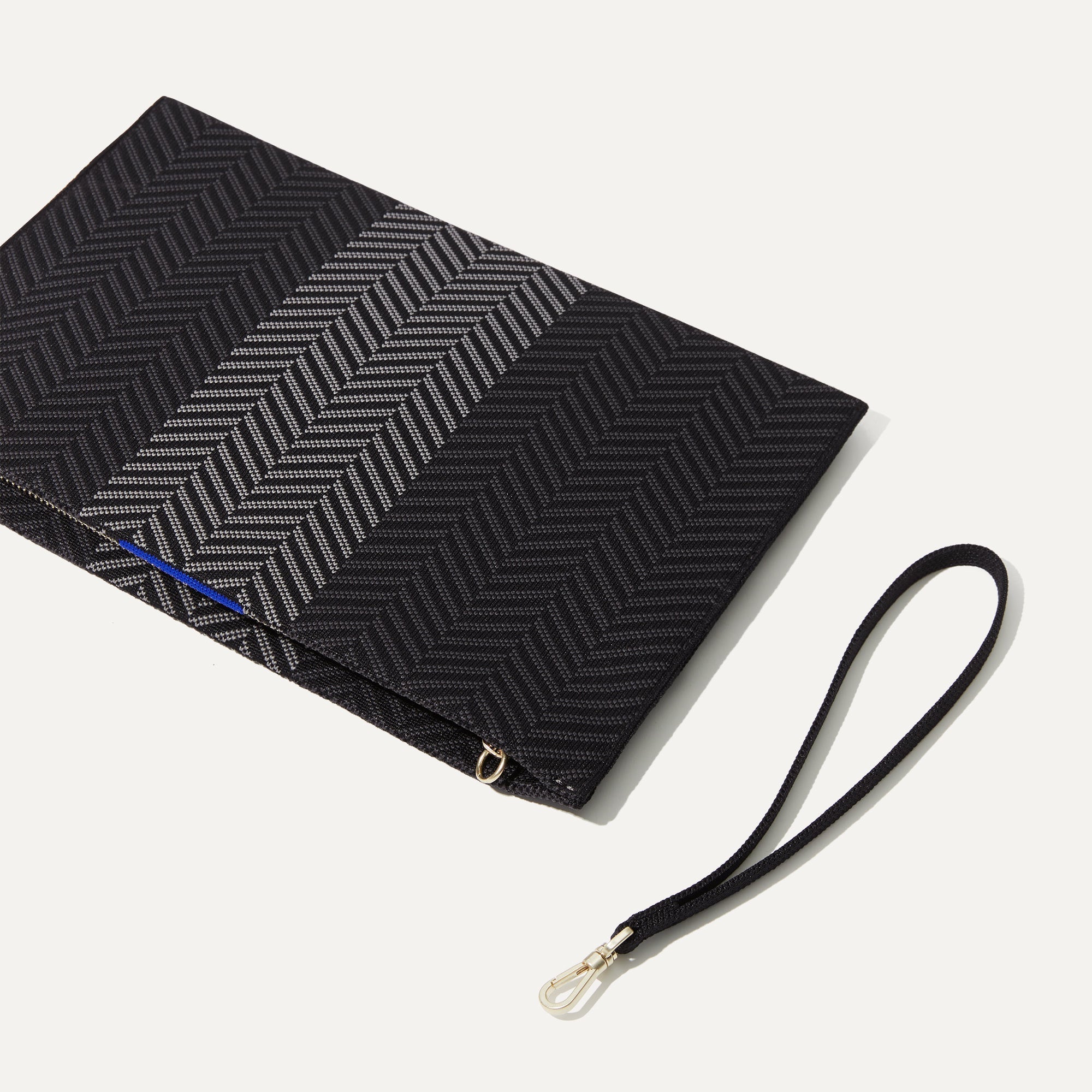 The Wristlet in Shadow Black shown with the wrist strap detached.