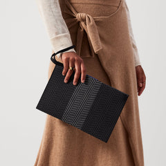 hover | Model holding The Wristlet in Shadow Black.