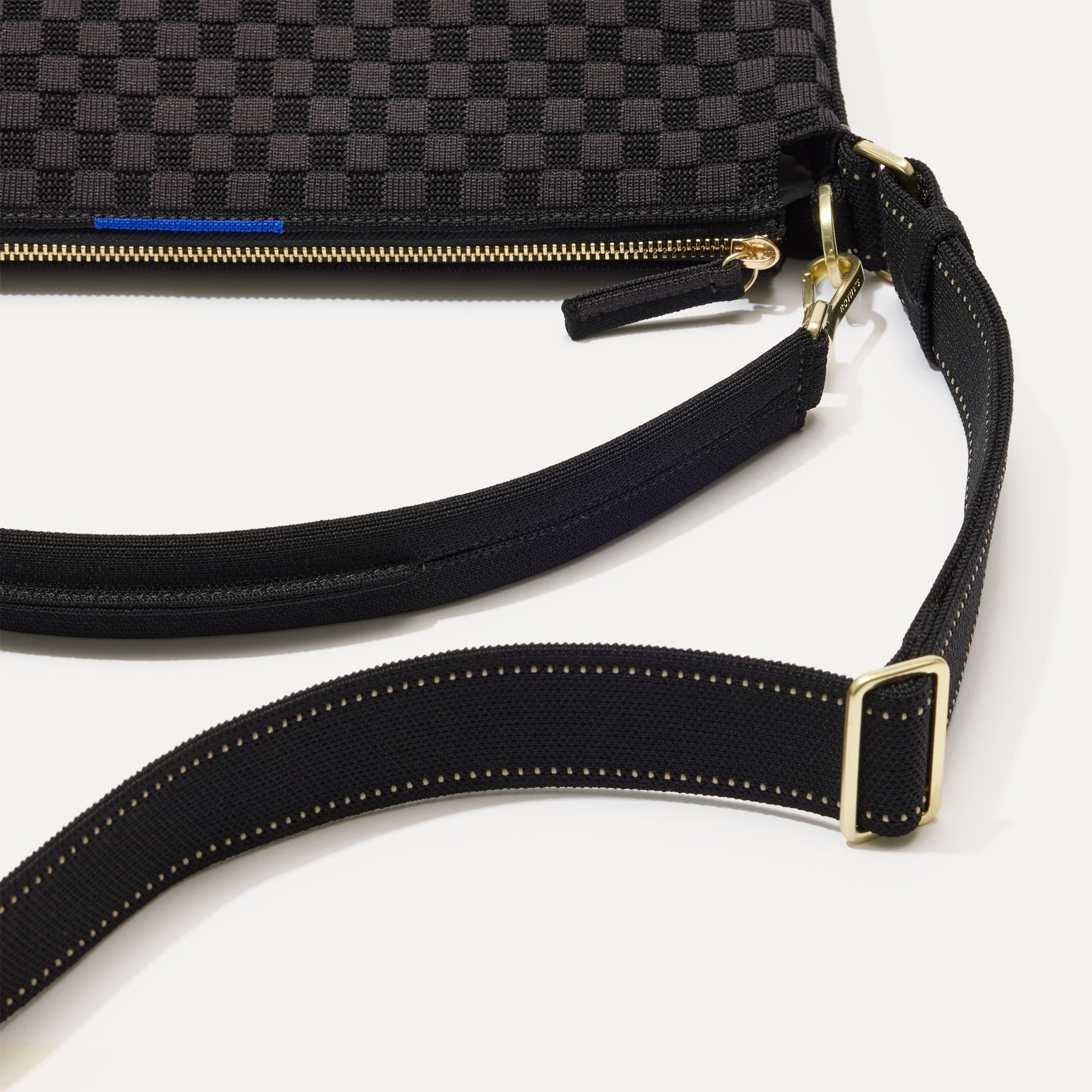 The Mini Zip Bucket in Black Sand lying flat, shown at a diagonal view from the left.