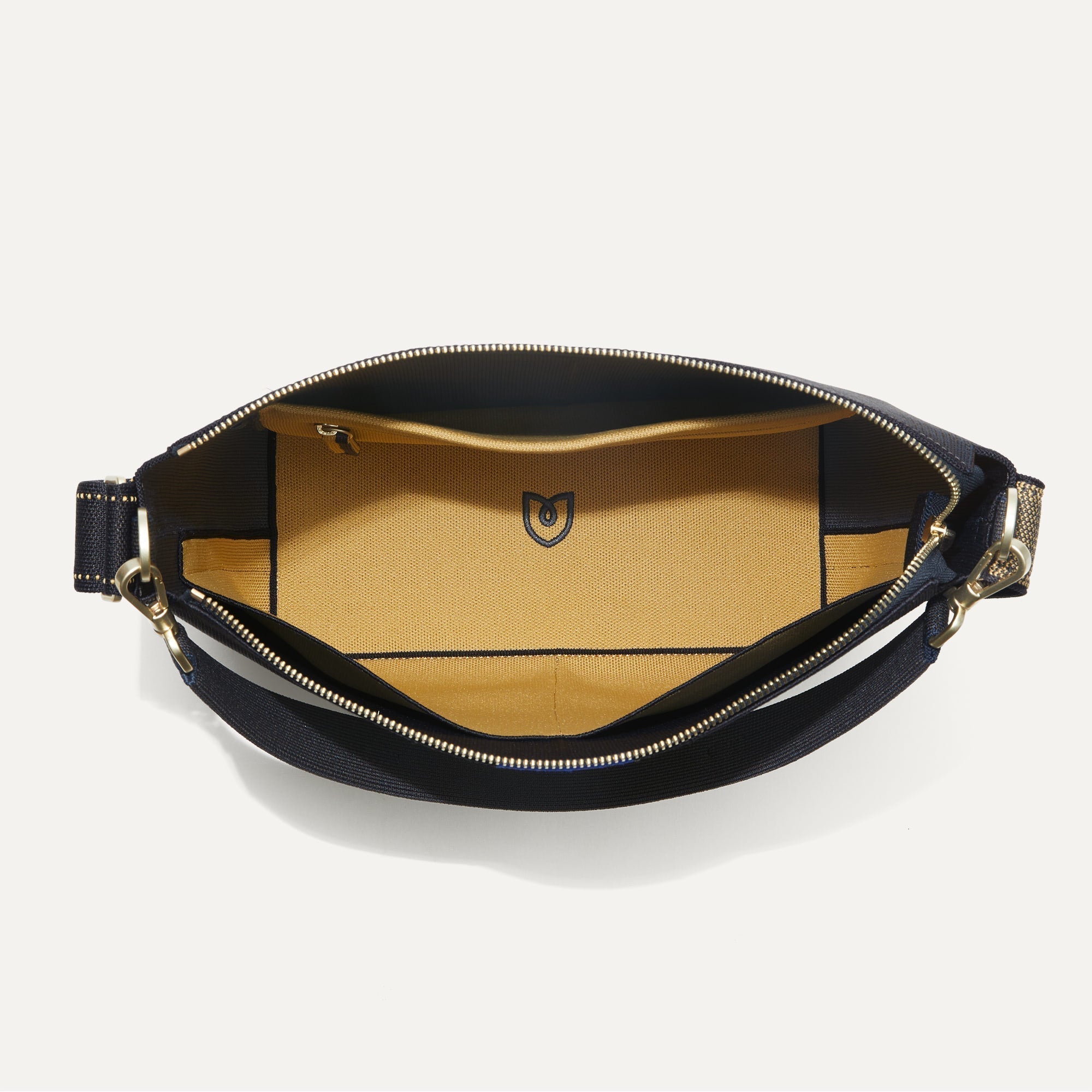 The Mini Zip Bucket in Ink and Ivory shown from the top down, with zipper open and interior exposed.