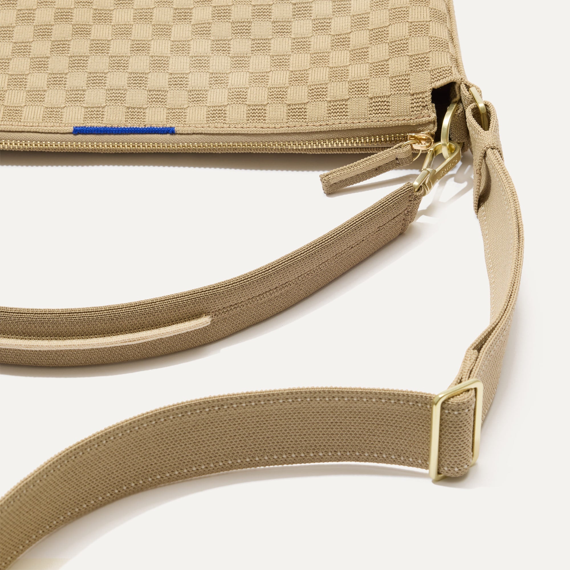 The Mini Zip Bucket in Knot Brown lying flat, shown at a diagonal view from the left.