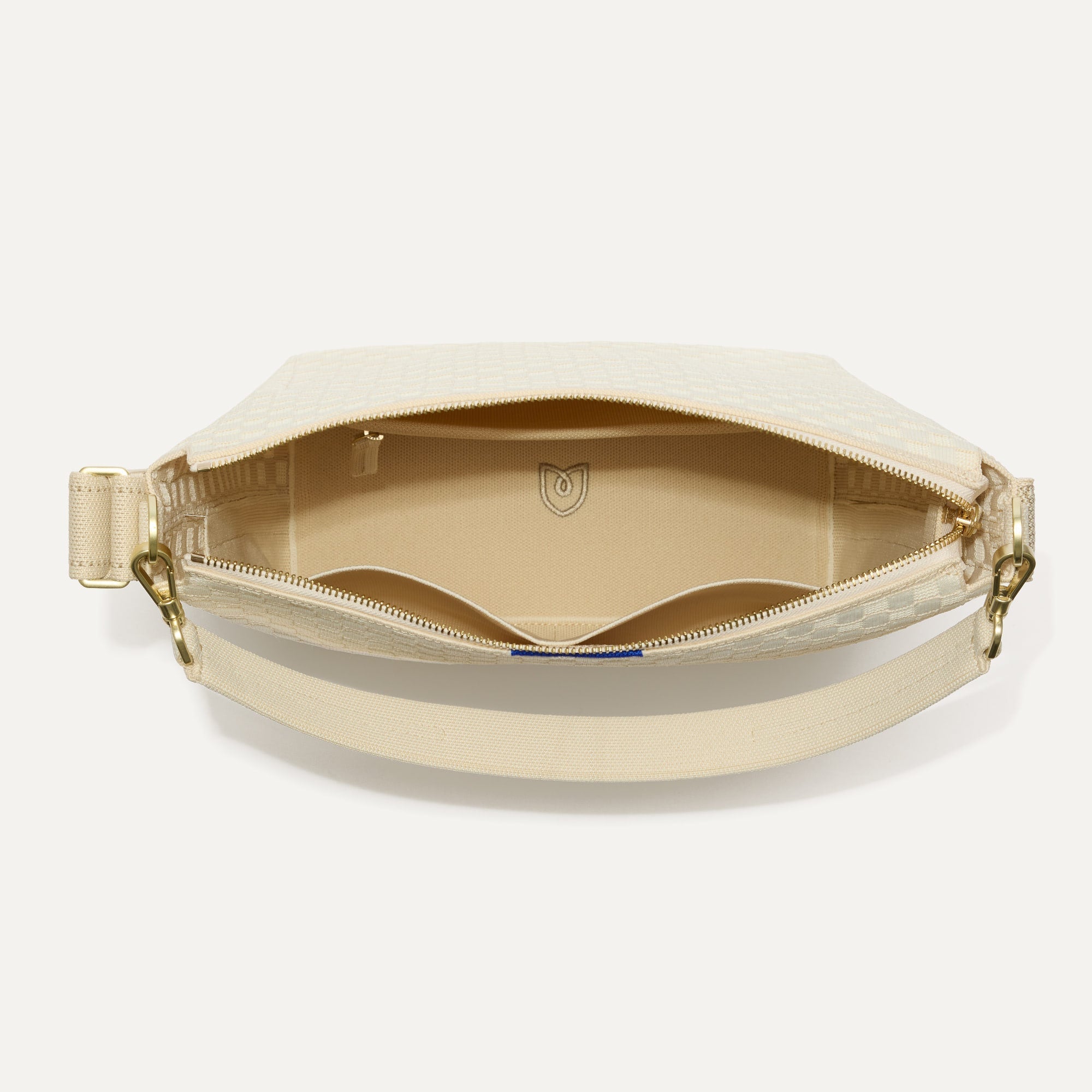 The Mini Zip Bucket in White Sand shown from the top down, with zipper open and interior exposed.