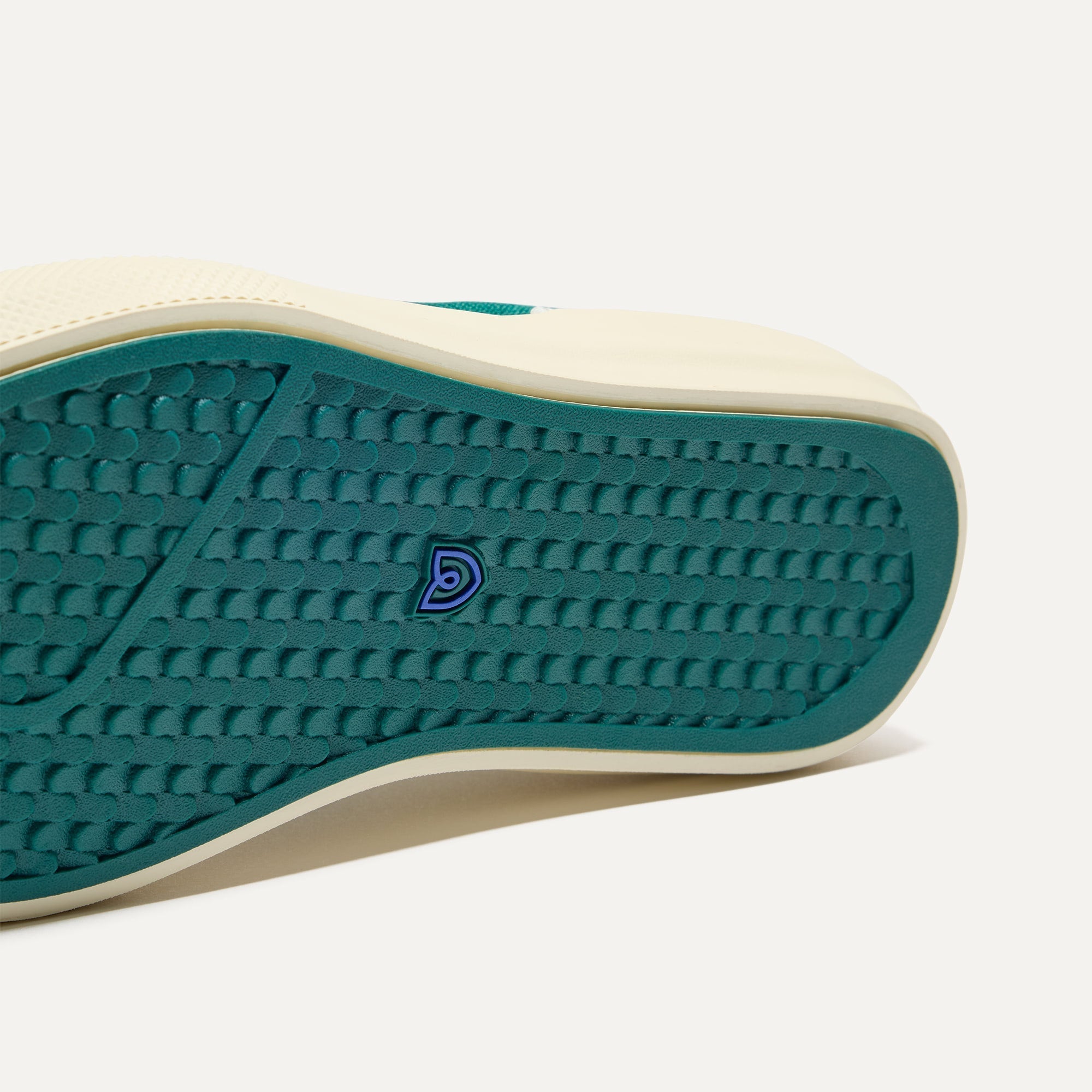 Close up of the outsoles of The RS02 Sneaker in Kelly, with raised grooves for added traction.