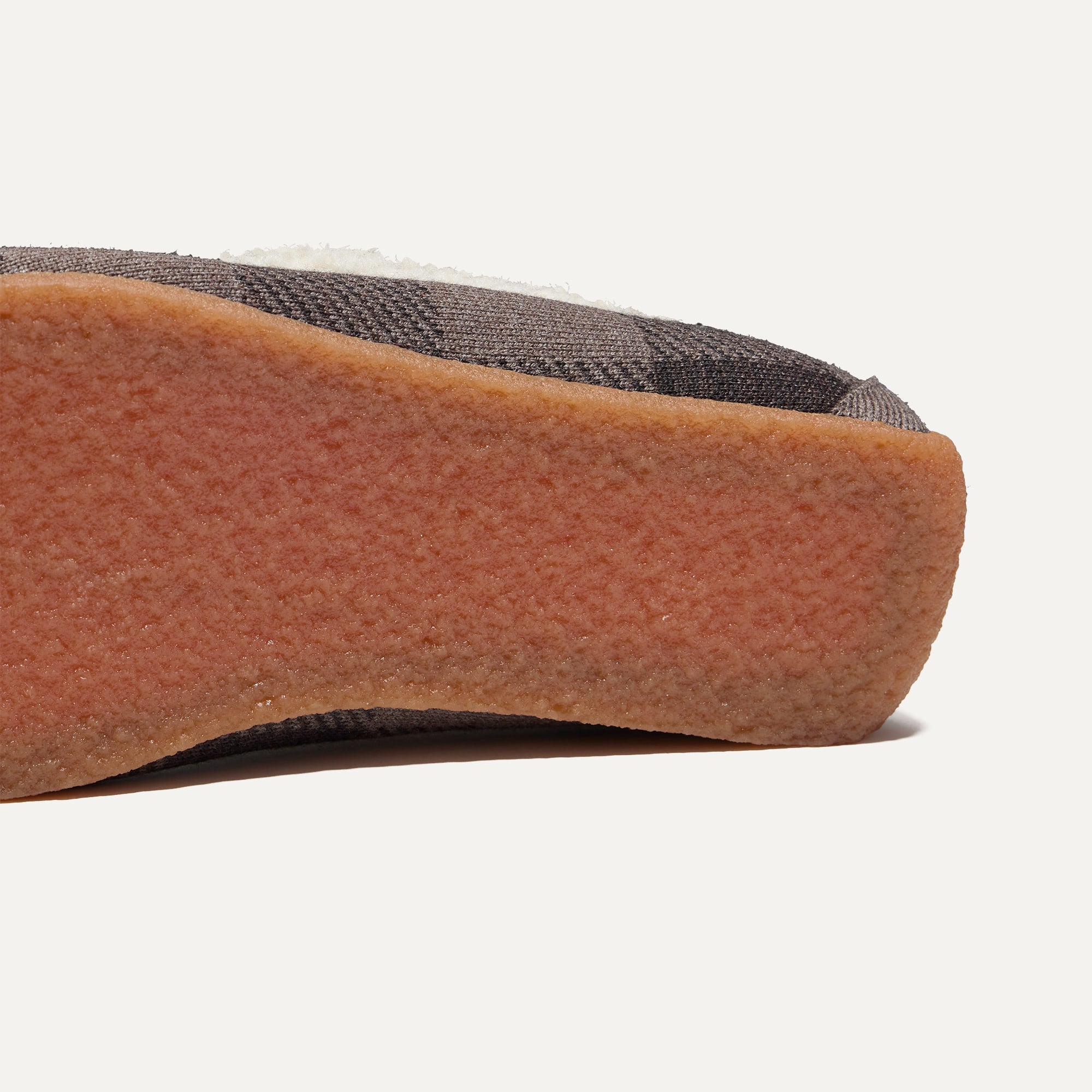 Close up of the outsoles of The Men's Slipper in Brown Buffalo Check.