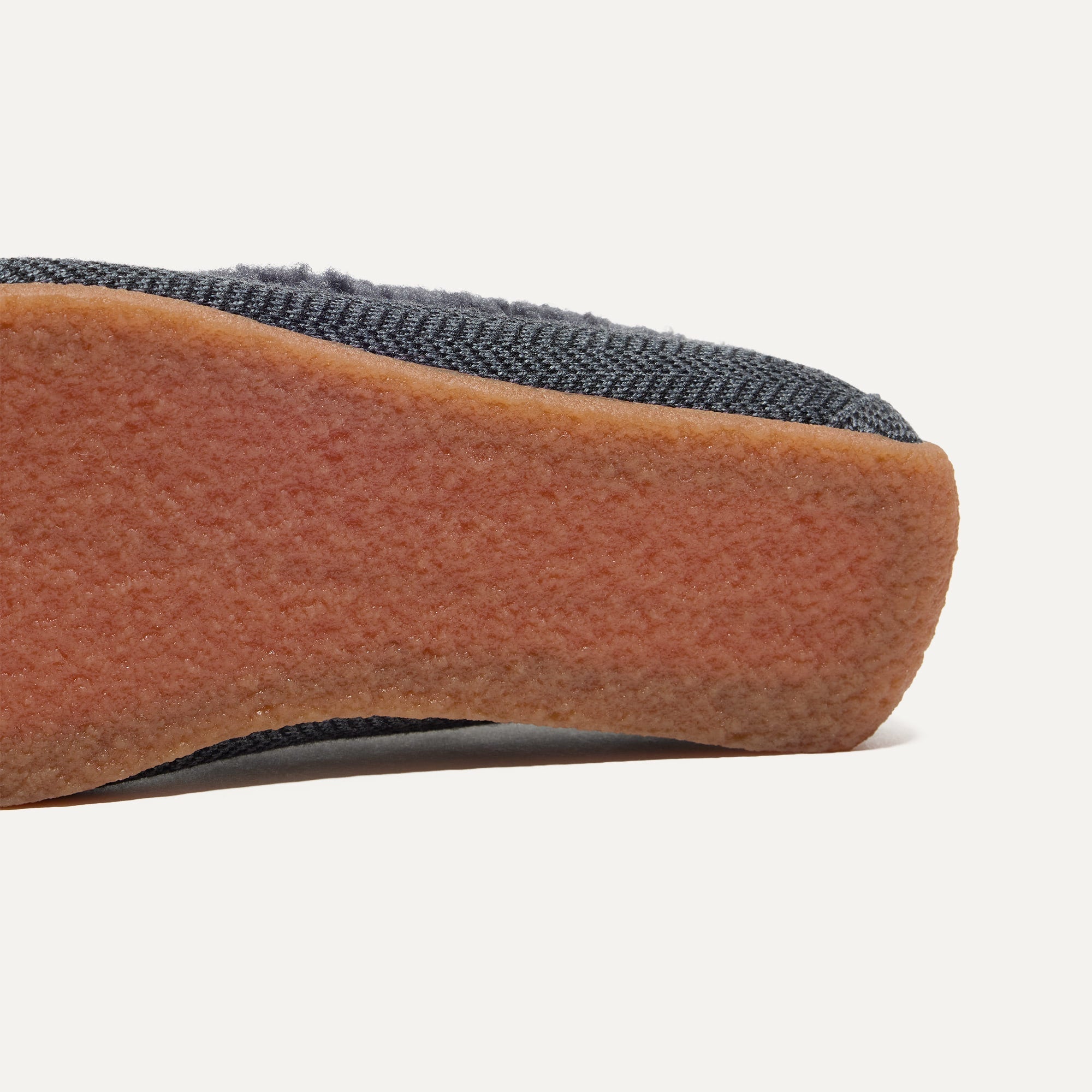 Close up of the outsoles of The Men's Slipper in Charcoal Herringbone.