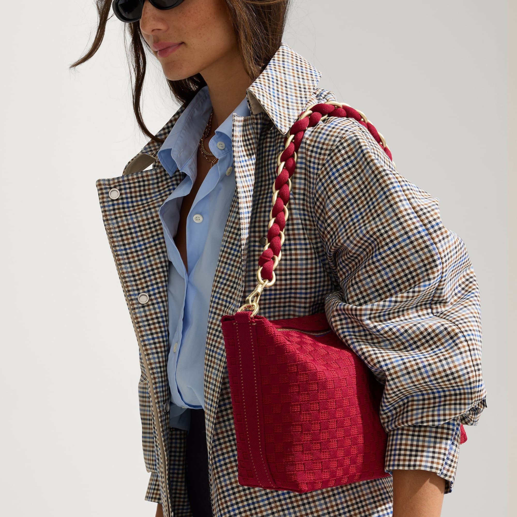 The Shoulder Strap in Cranberry Chain, shown paired with The Daily Crossbody, worn by a model and shown from the side. 