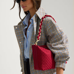 The Shoulder Strap in Cranberry Chain, shown paired with The Daily Crossbody, worn by a model and shown from the side. 