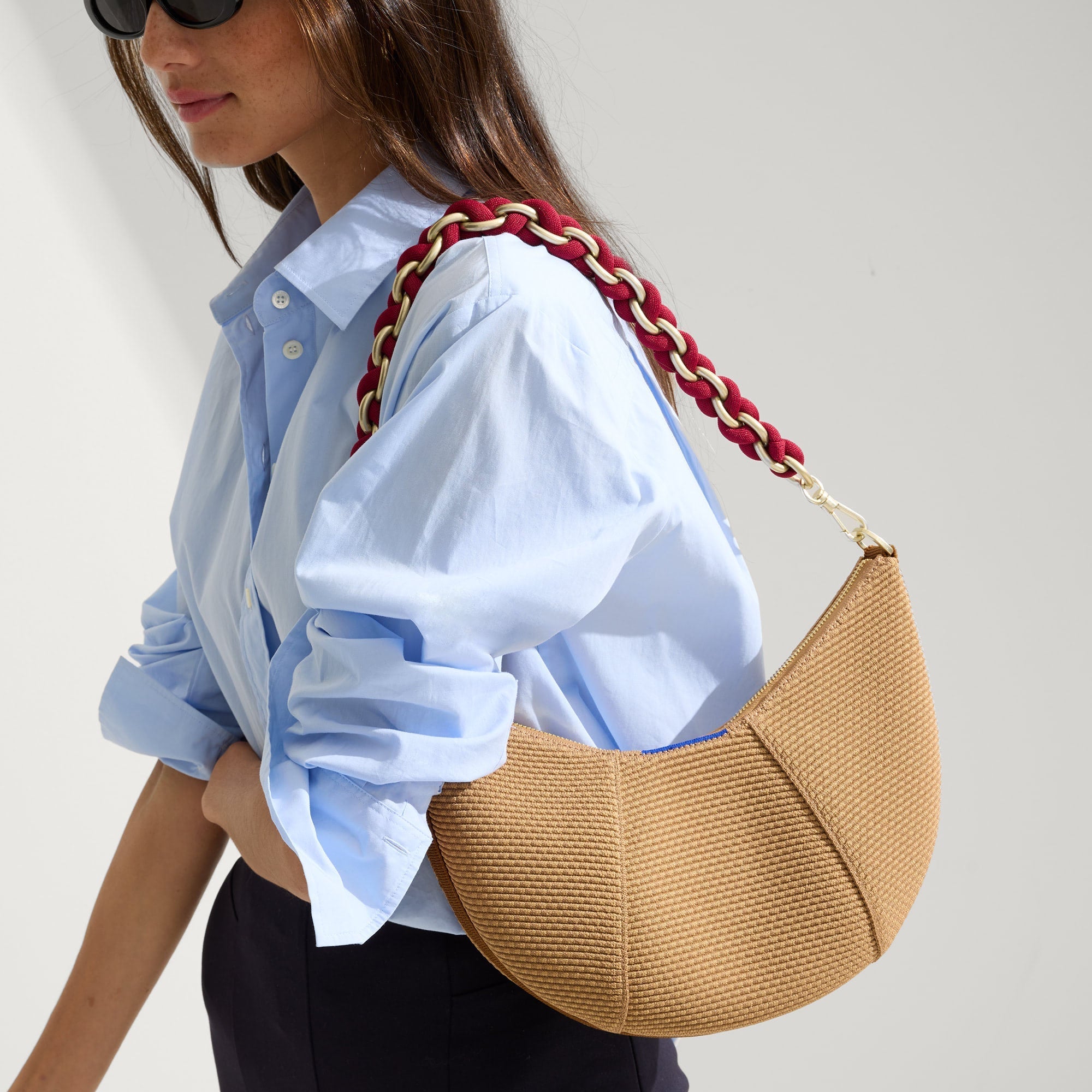 hover | The Shoulder Strap in Cranberry Chain, shown paired with The Crescent Bag, worn by a model and shown from the side. 