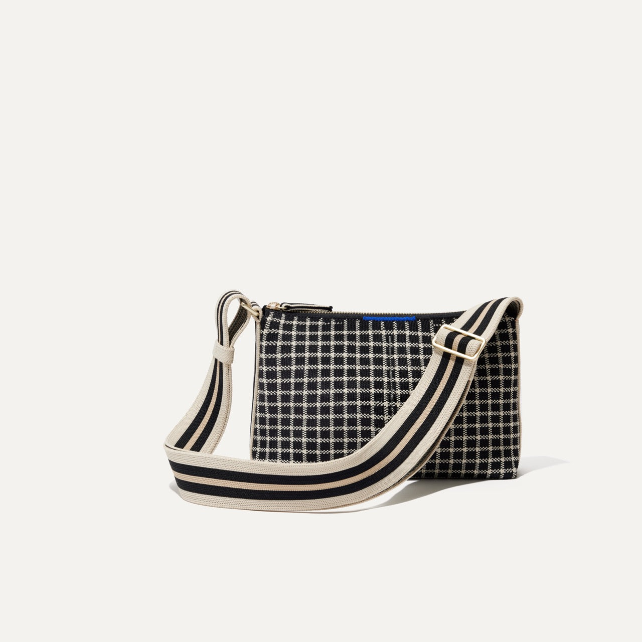 PLP |The Casual Crossbody in Black and Ivory Grid, shown from the front.