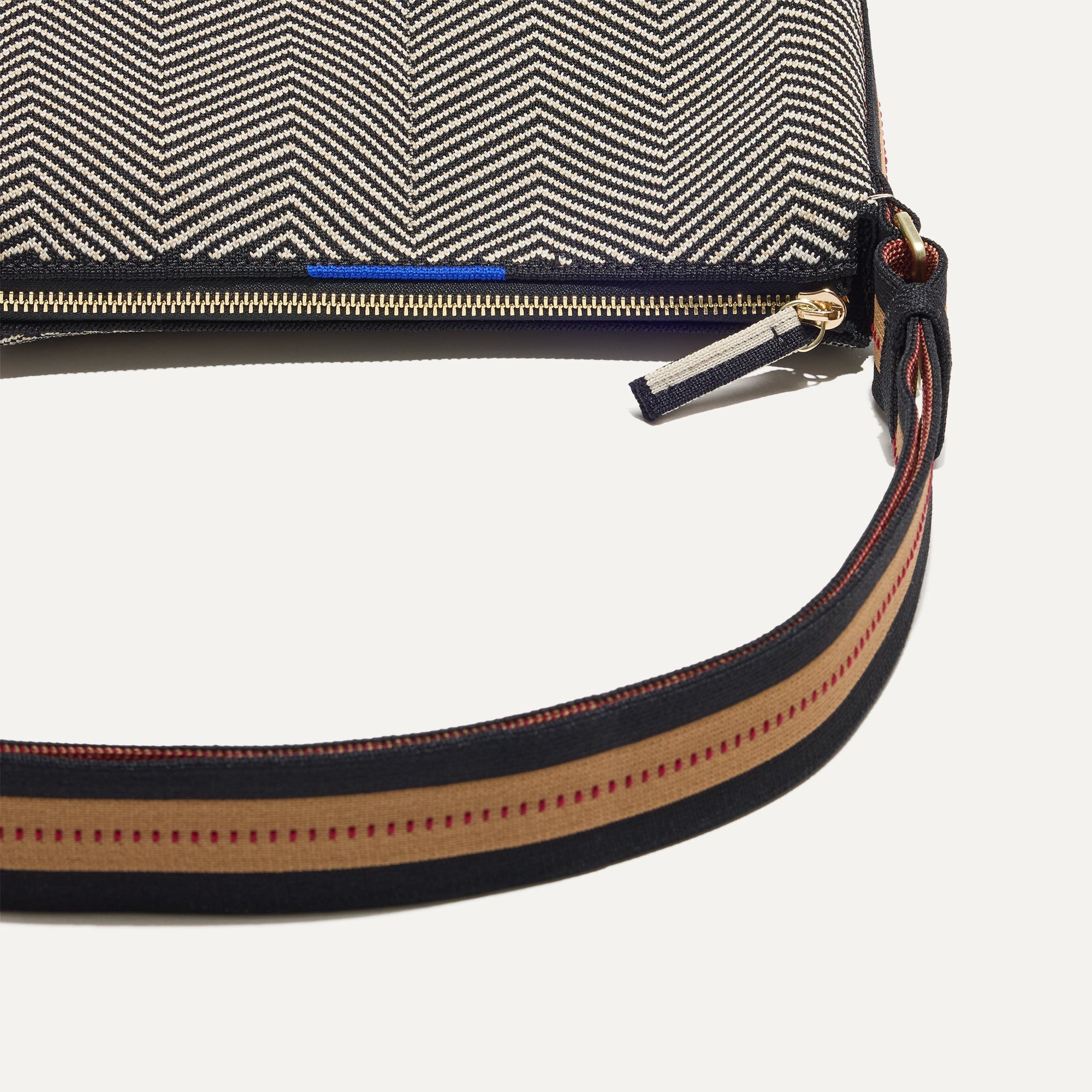 A closeup of The Casual Crossbody in Dark Mist, focusing on the crossbody strap. 