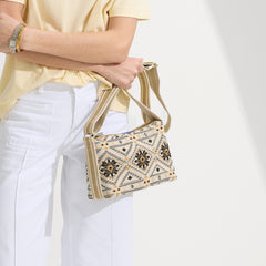 hover | The Casual Crossbody in Desert Mosaic, carried by its crossbody strap by a model.