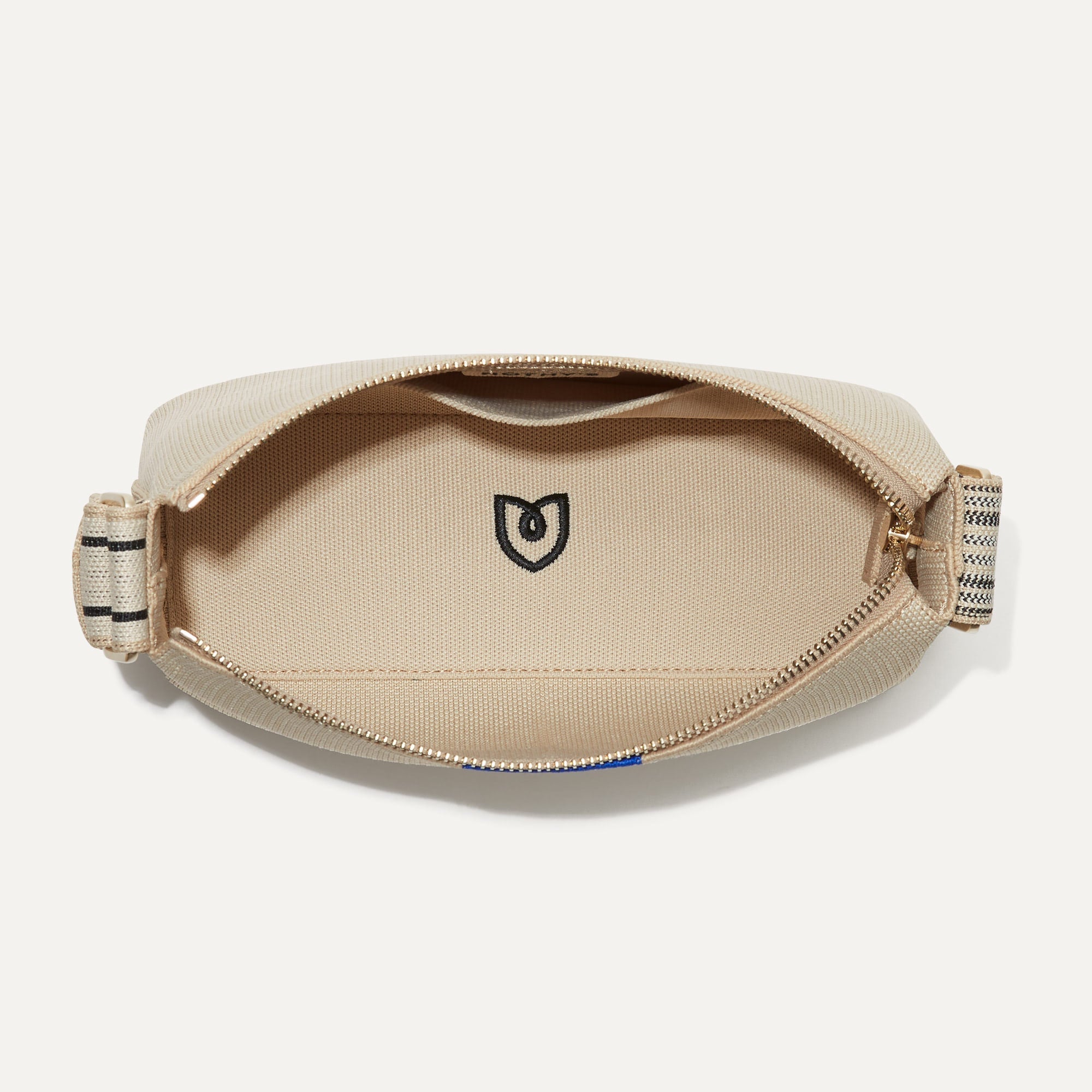 The Casual Crossbody in Parchment, shown from above, with the interior exposed. 
