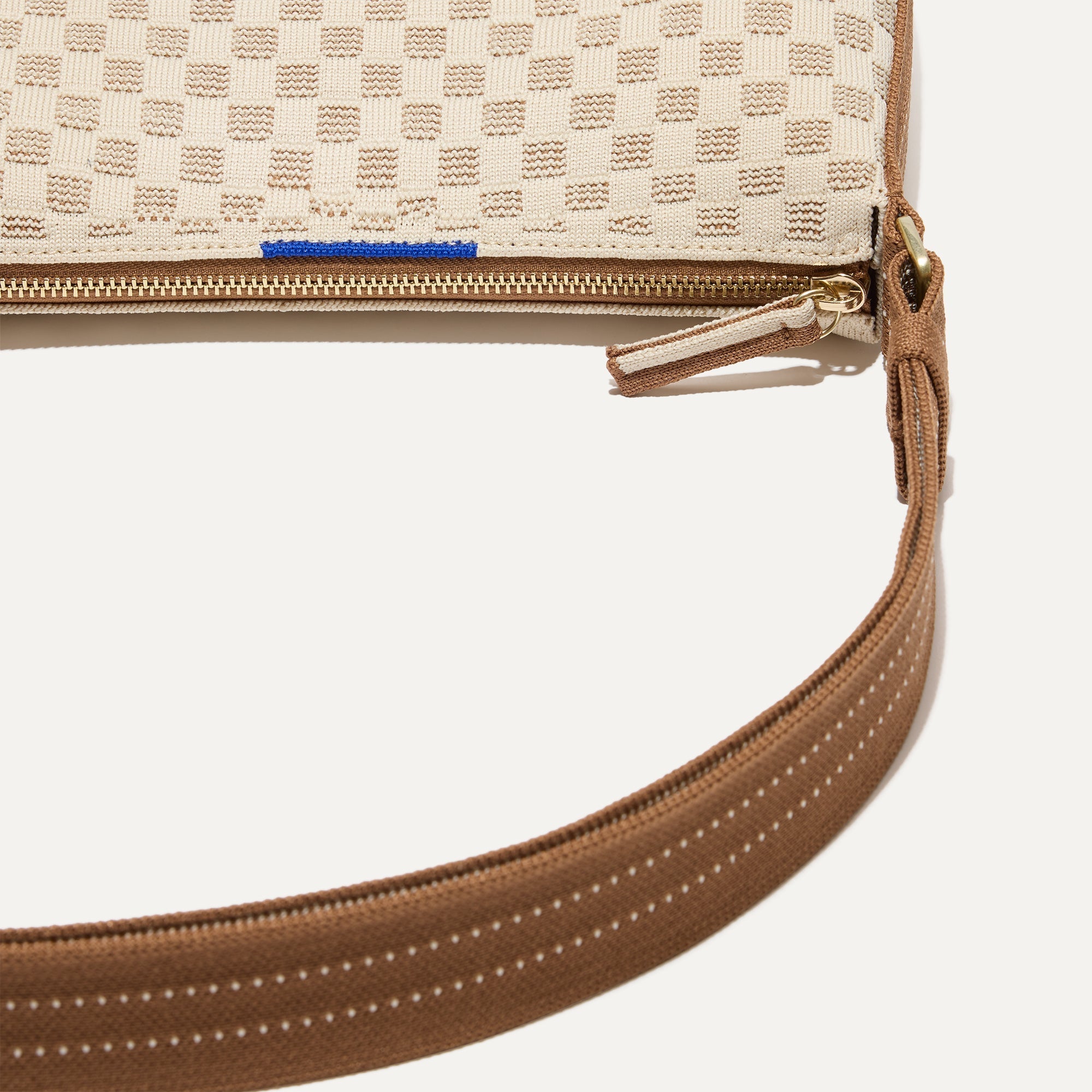 A closeup of The Casual Crossbody in Vanilla Wafer, focusing on the crossbody strap. 
