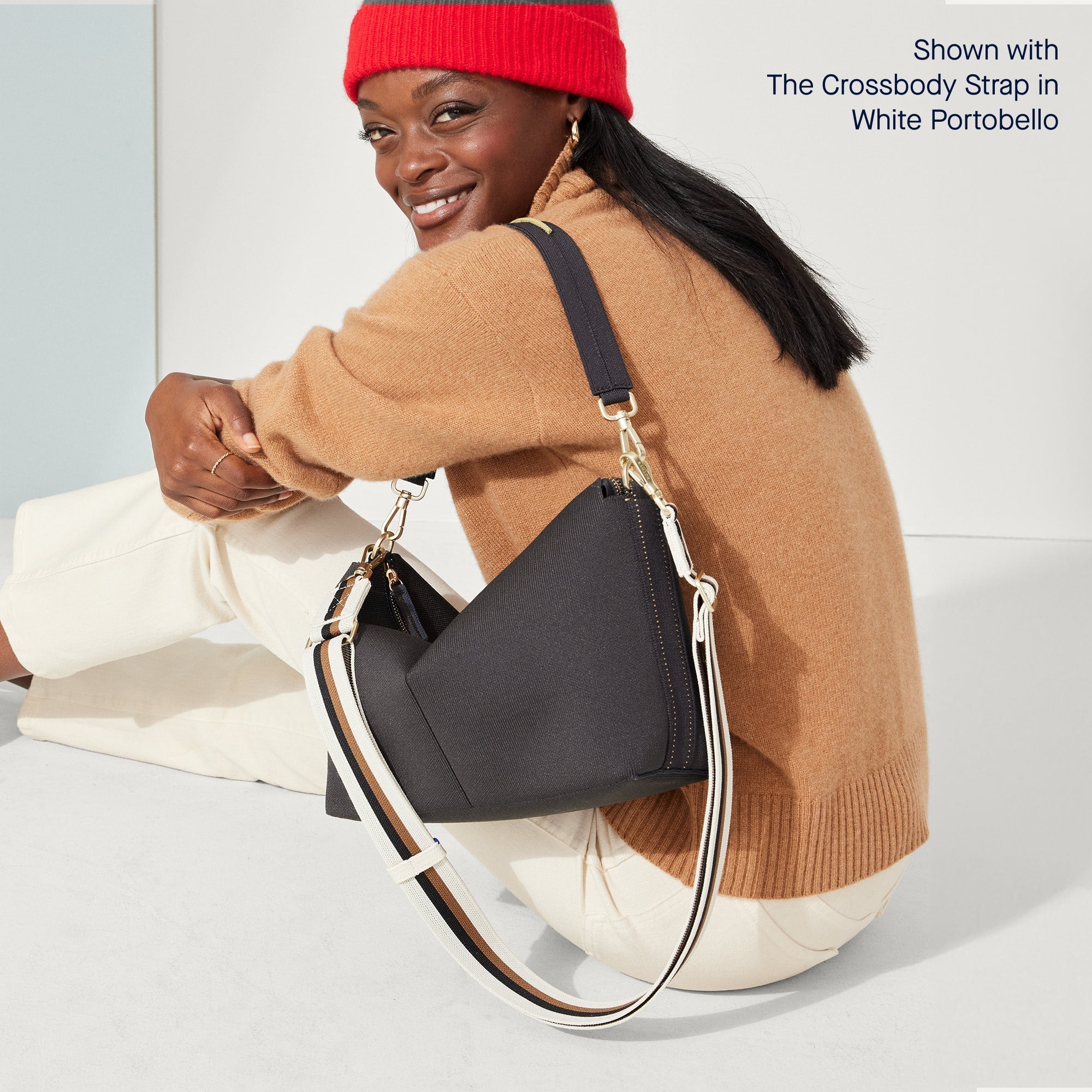 Model wearing The Daily Crossbody in Ink & Ivory shown paired with the Crossbody Strap White Portobello Stripe.