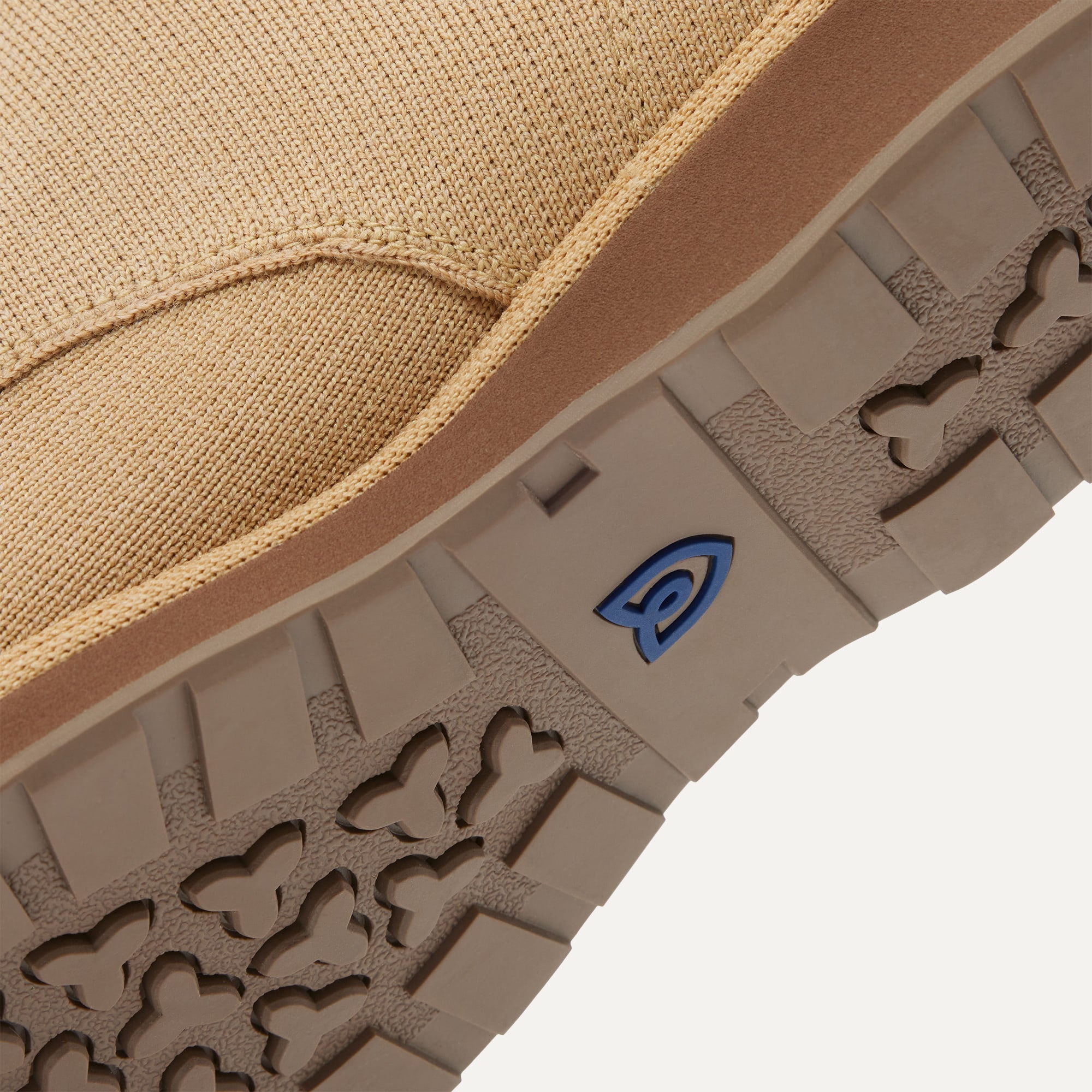 Close up of the outsoles of The Chukka Boot in Desert Sand, with raised grooves for added traction. 