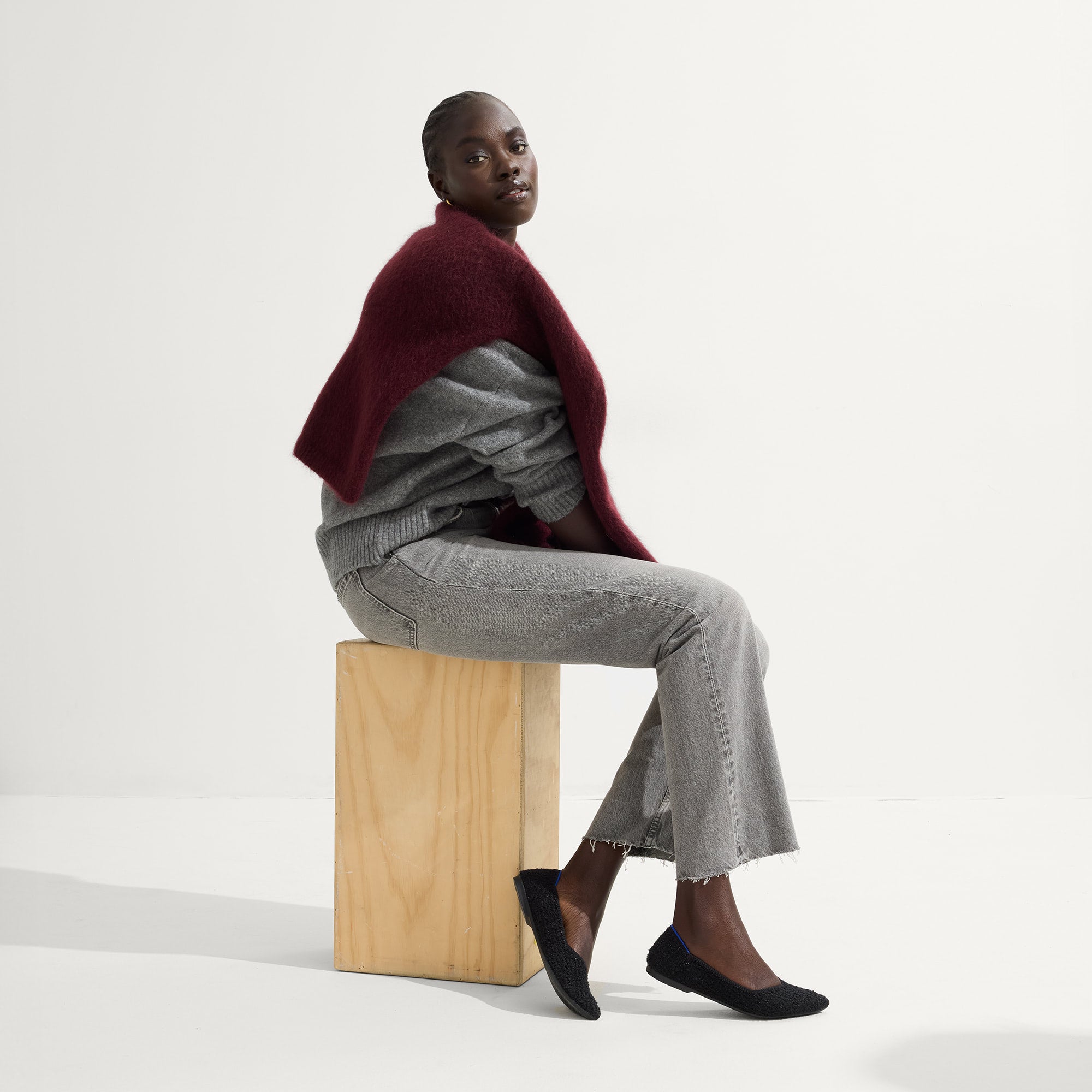 Alternate view of a model wearing The Point II in Black Boucle.