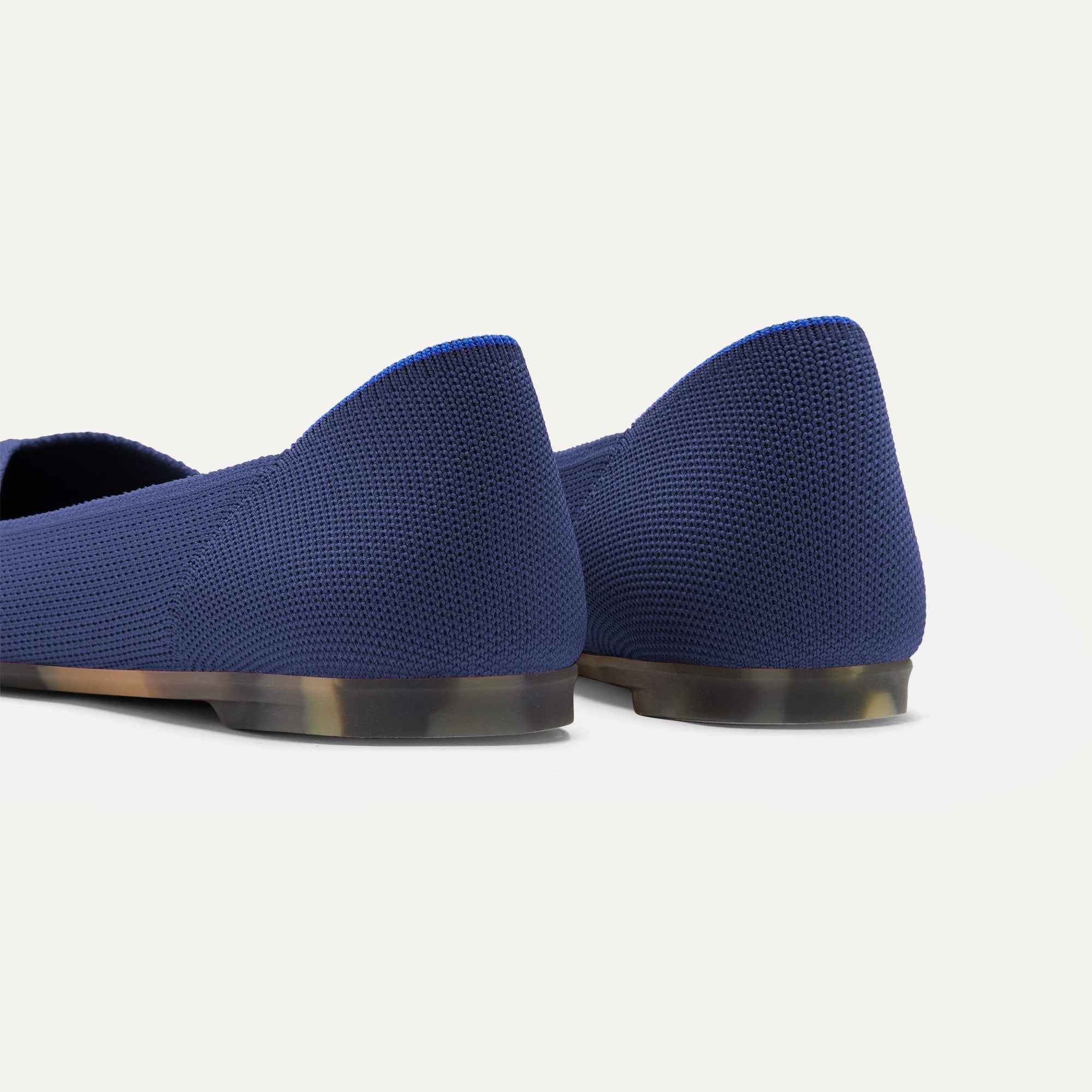 Close up of the heel of The Point II in Deep Navy, with Rothy's signature blue halo.