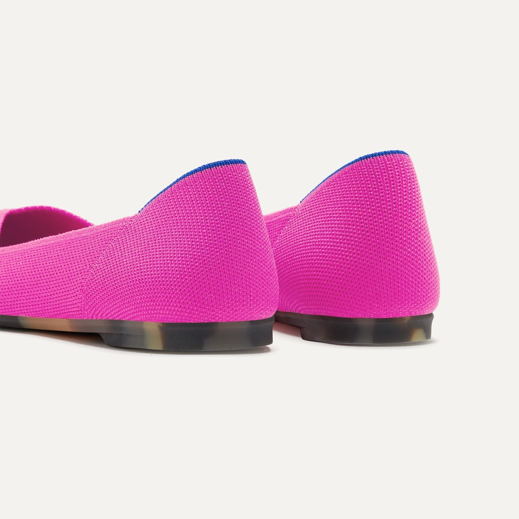 Close up of the heel of The Point II in Dragon Fruit, with Rothy's signature blue halo.