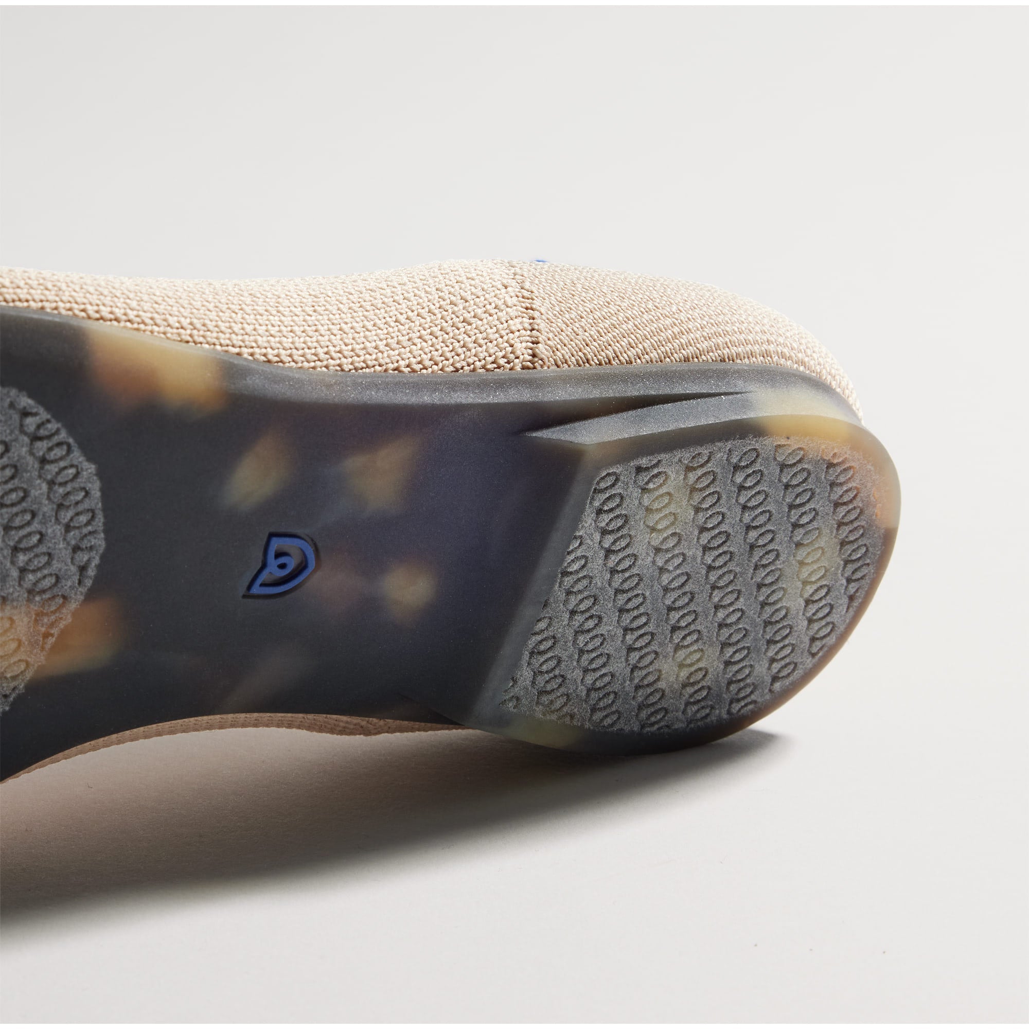 Close up of the outsole of The Point II in Ecru, shown in a diagonal view.