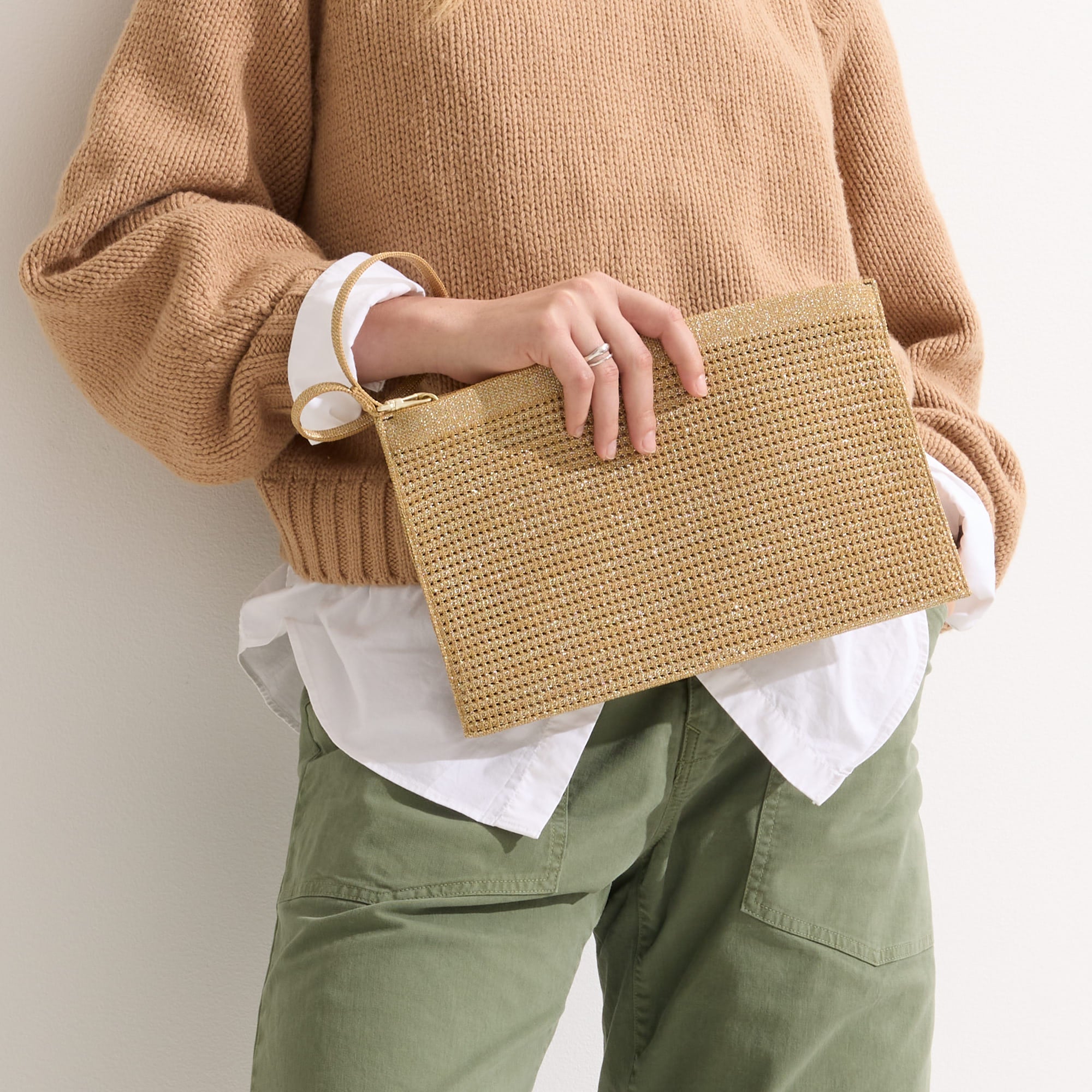hover | Model holding The Wristlet in Golden Perf.