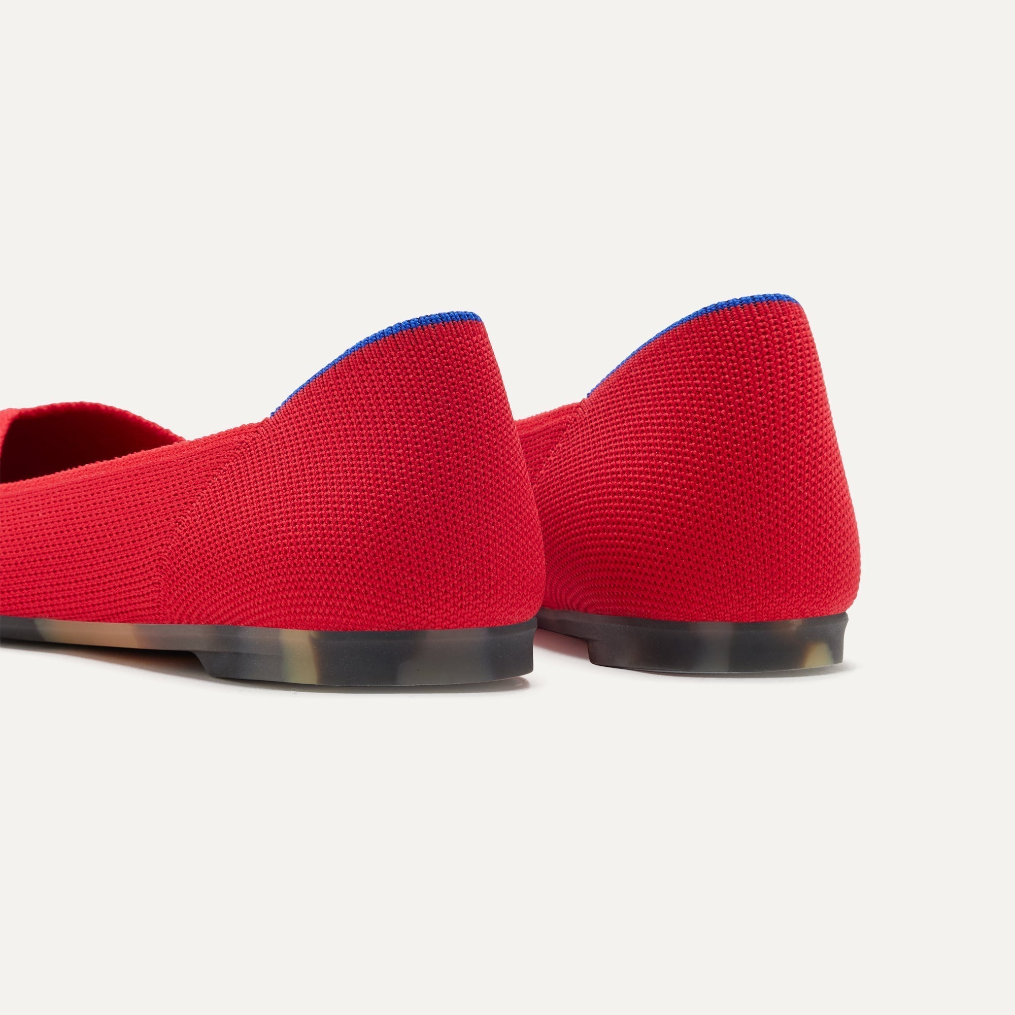 Close up of the heel of The Point II in Lollipop Red, with Rothy's signature blue halo.