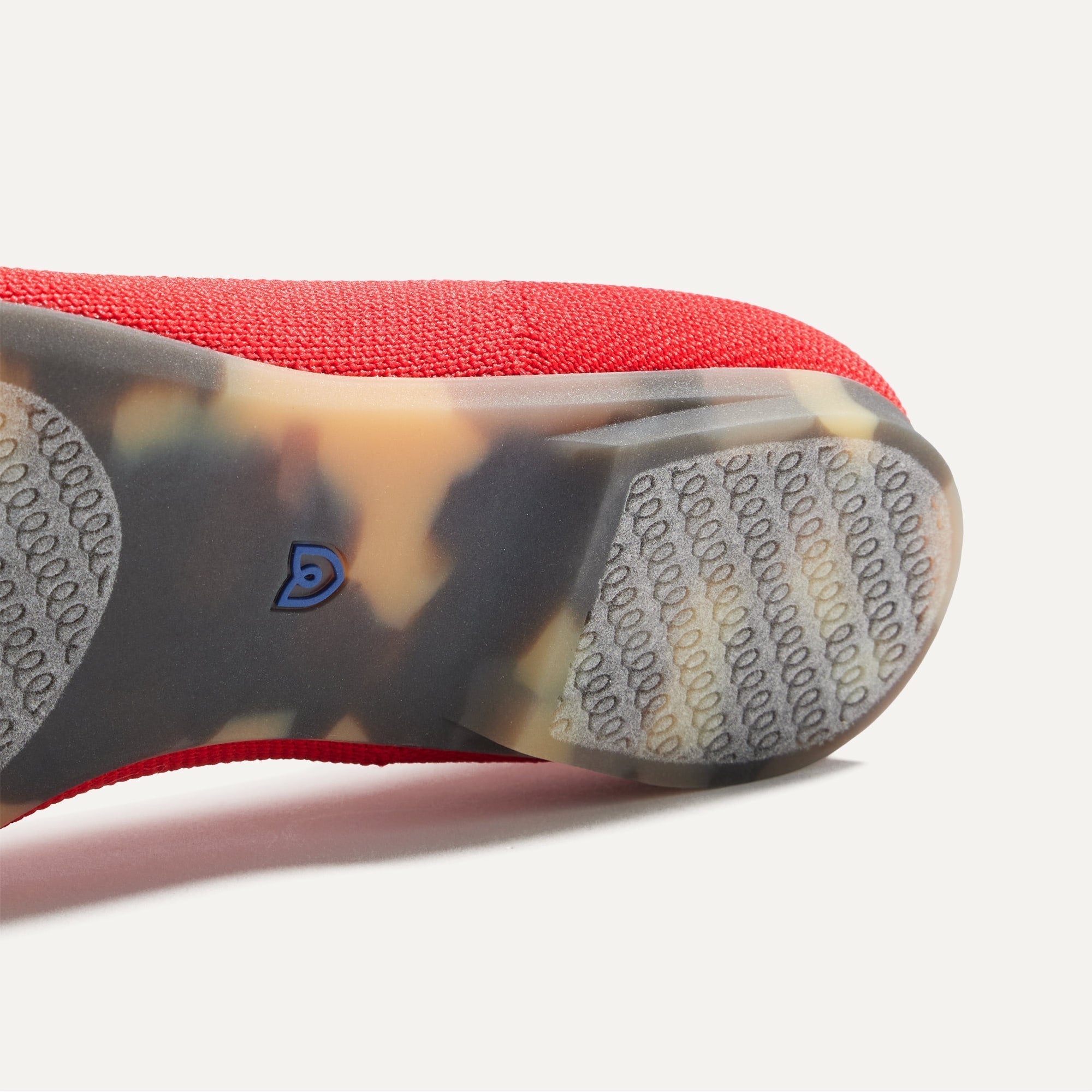 Close up of the outsole of The Point II in Lollipop Red, shown in a diagonal view.