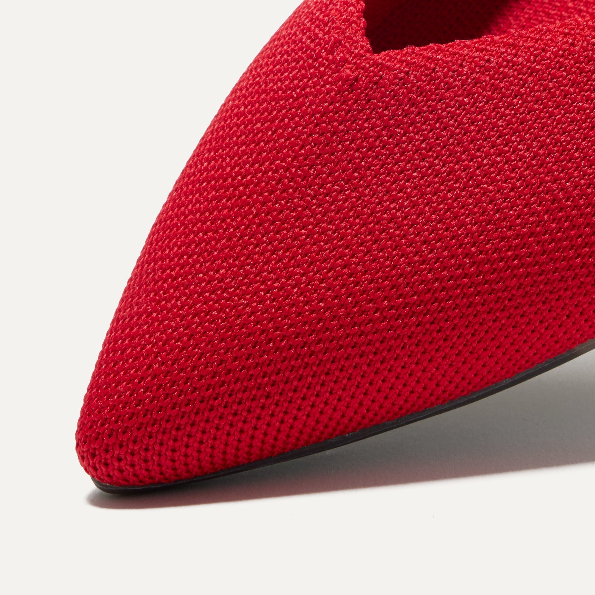 Close up of The Point II in Lollipop Red, shown in diagonal view.