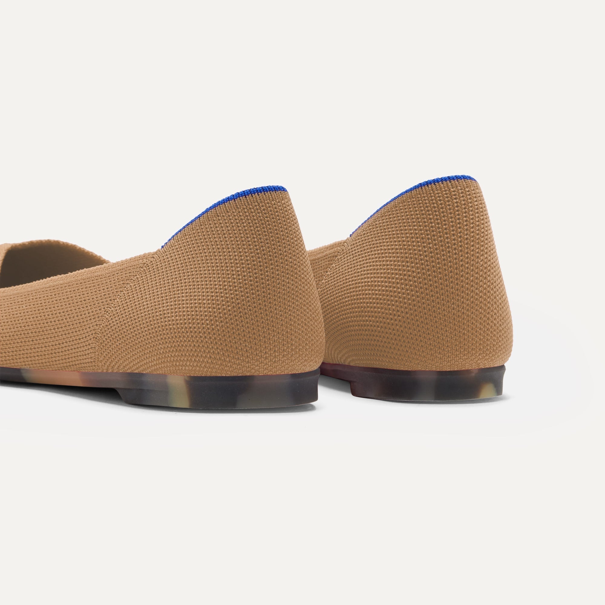 Close up of the heel of The Point II in Wren, with Rothy's signature blue halo.