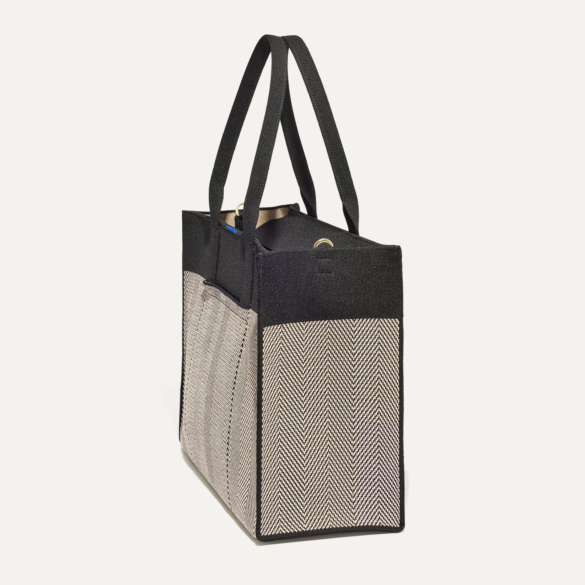 The Classic Tote in Black Herringbone, shown from the side.