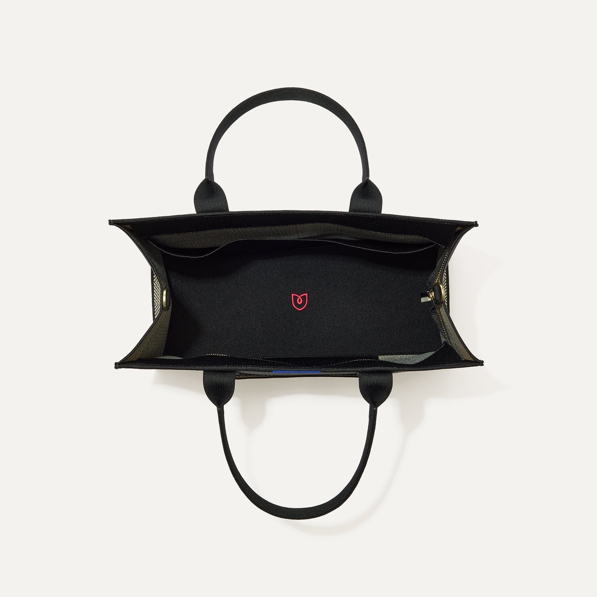 The Classic Tote in Black Herringbone, shown from above, with the interior exposed.