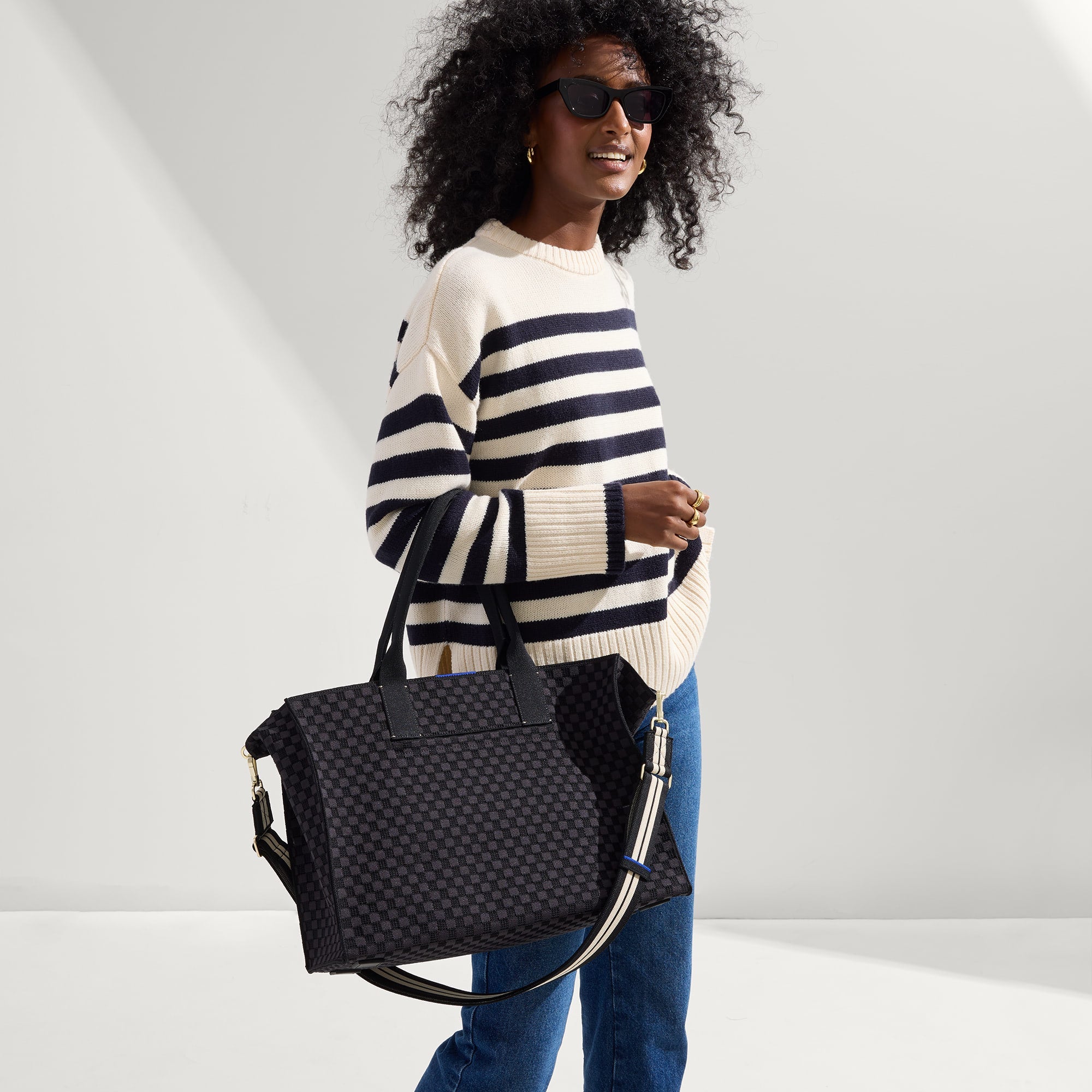 hover | The Crossbody Strap in Black and White Stripe, shown paired with The Classic Tote, worn by a model, shown from the side