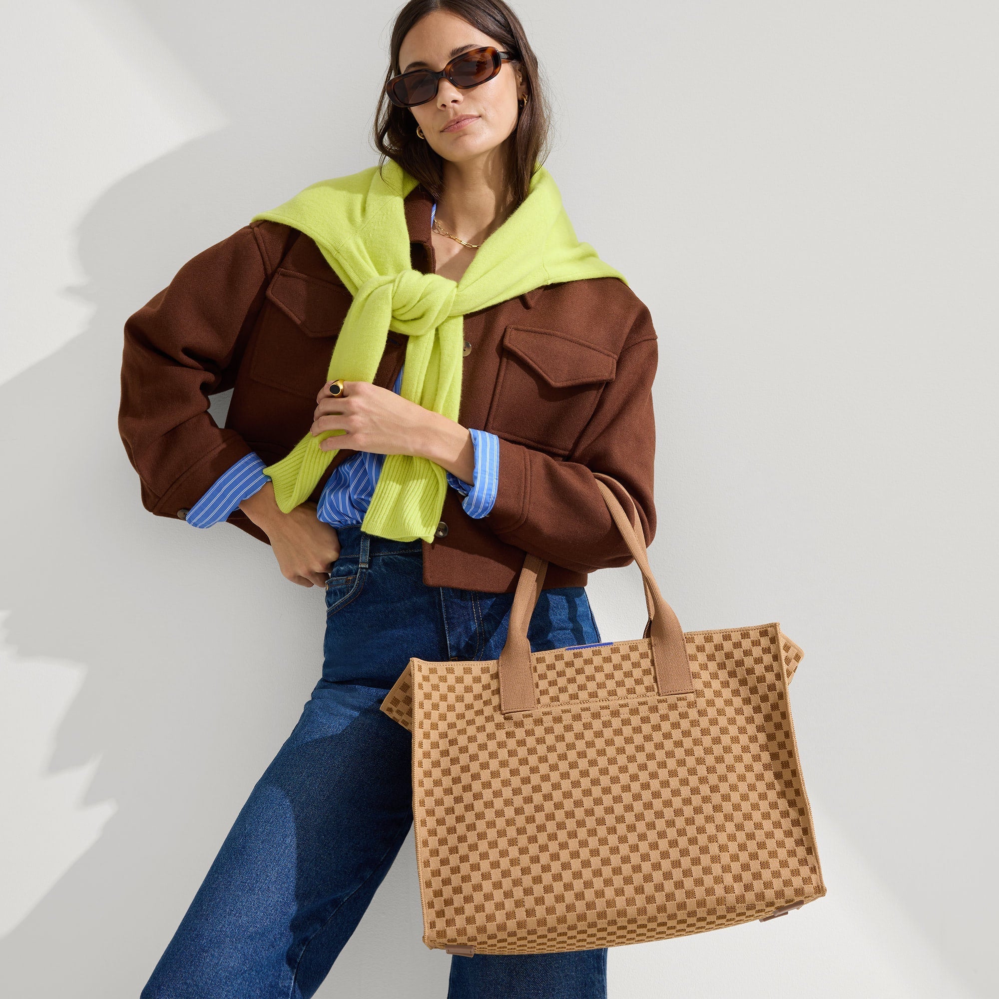 hover | The Classic Tote in Hazelnut, carried by its top handles by a model, shown from the front.