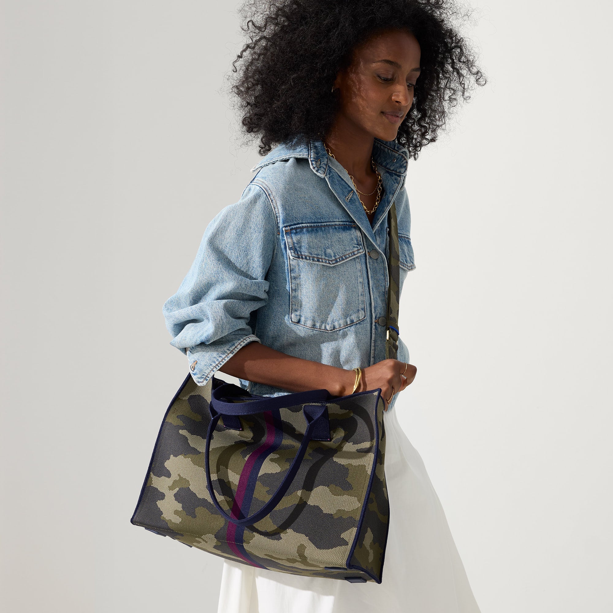 hover | The Classic Tote in Spruce Camo, worn over the shoulder by a model, shown from the side.