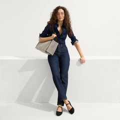 The Classic Tote in Black Herringbone, worn on the side.