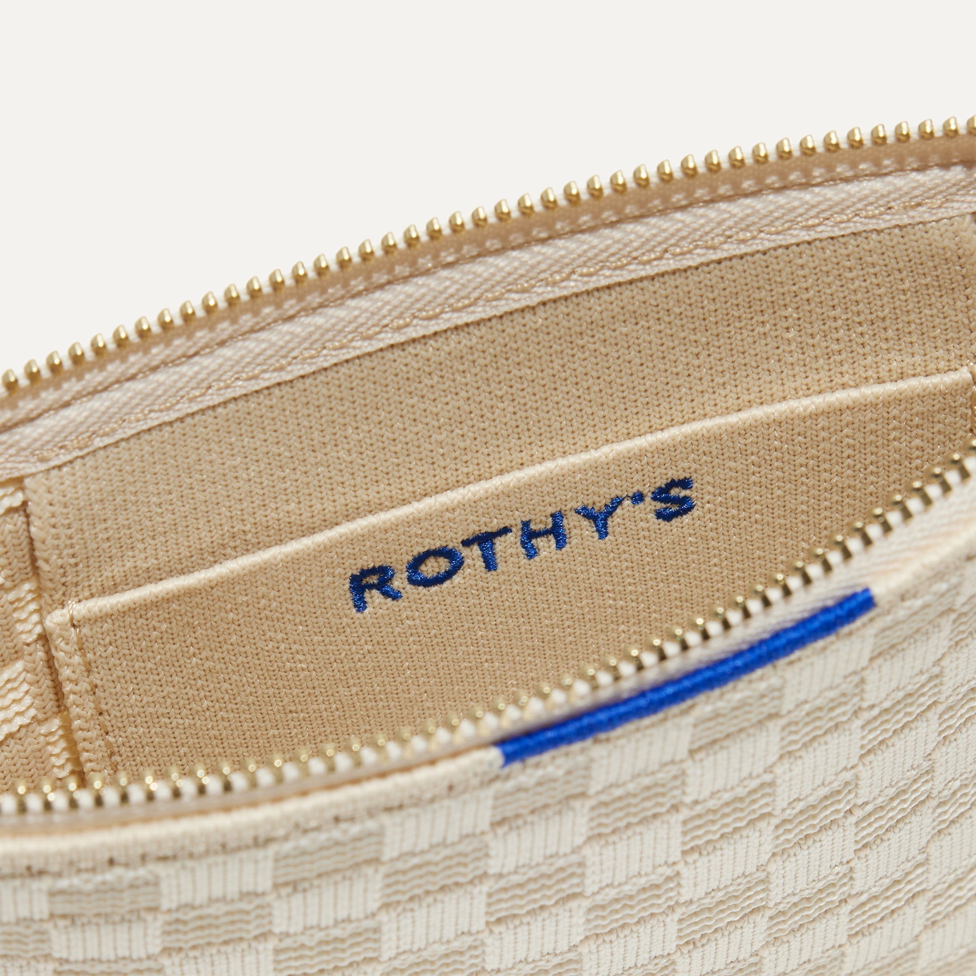 A closeup of The Wallet Wristlet in Vanilla Basketweave, focusing on the inner card slip.