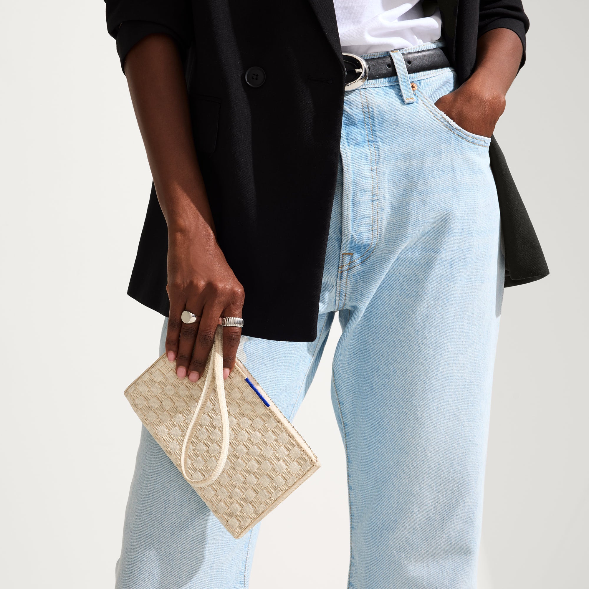 hover | The Wallet Wristlet in Vanilla Basketweave, held by a model, shown from the front.