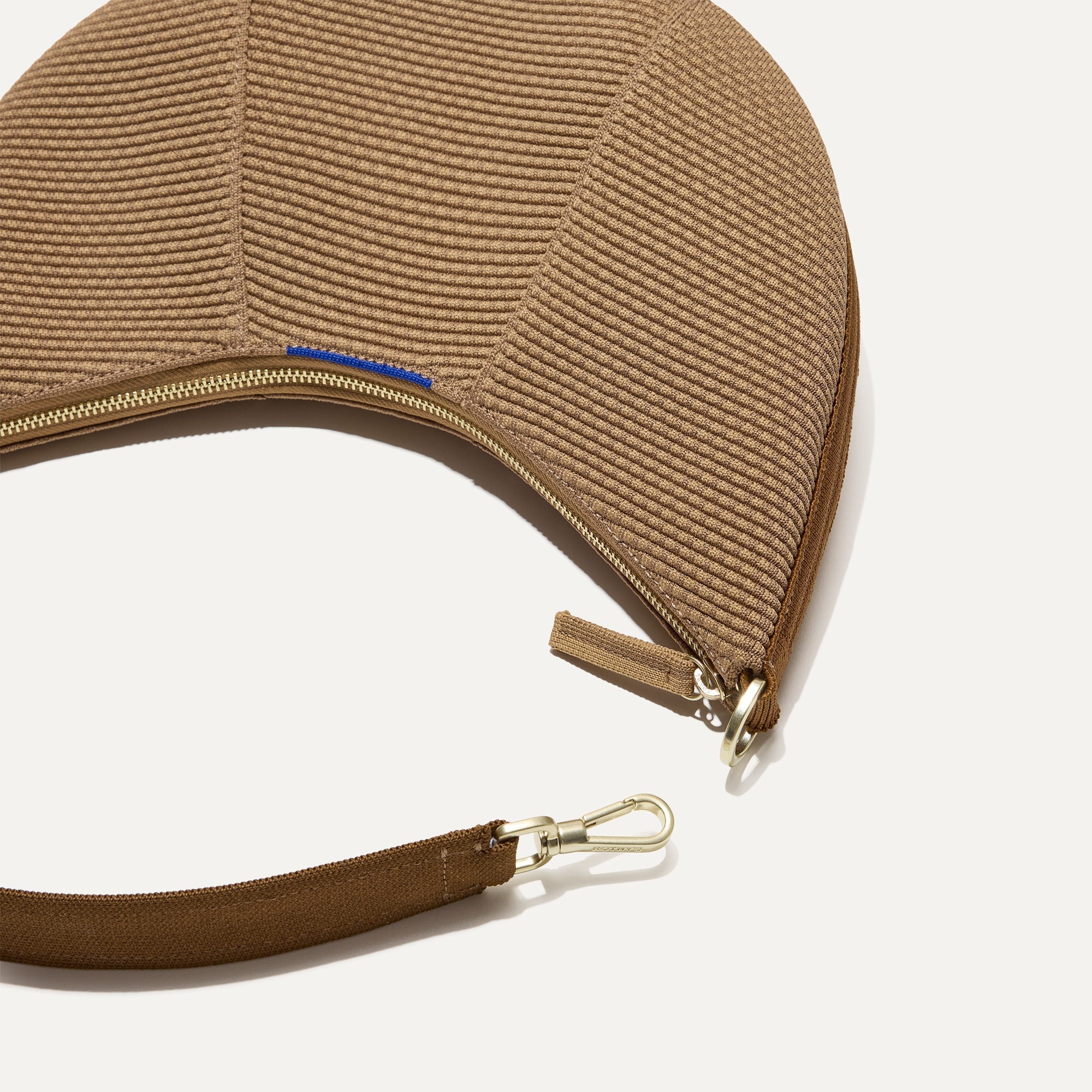 A close up of The Crescent Bag in Horizon, with the shoulder strap detached.