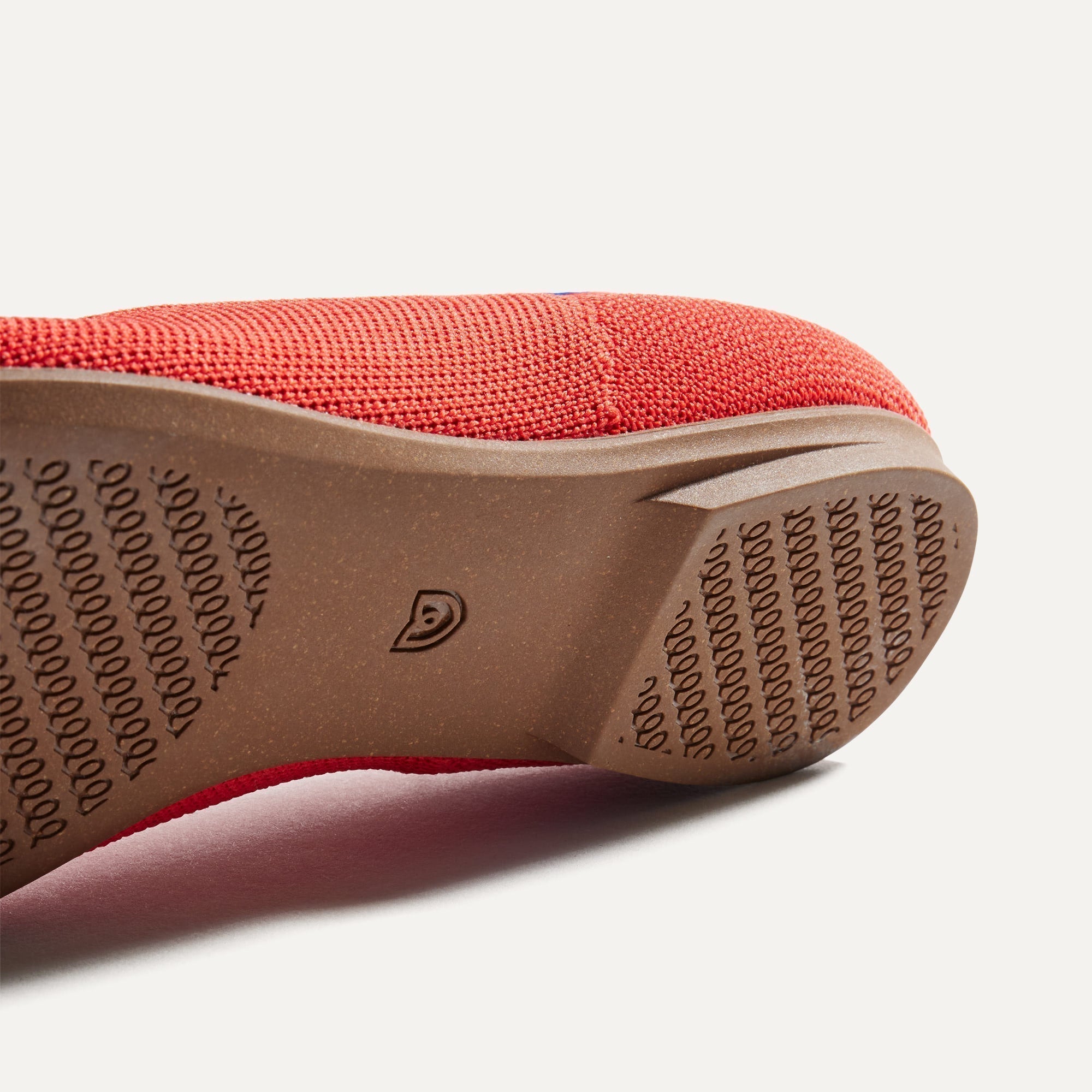 The sole of The Ballet Flat in Glamour Red shown in diagonal view.