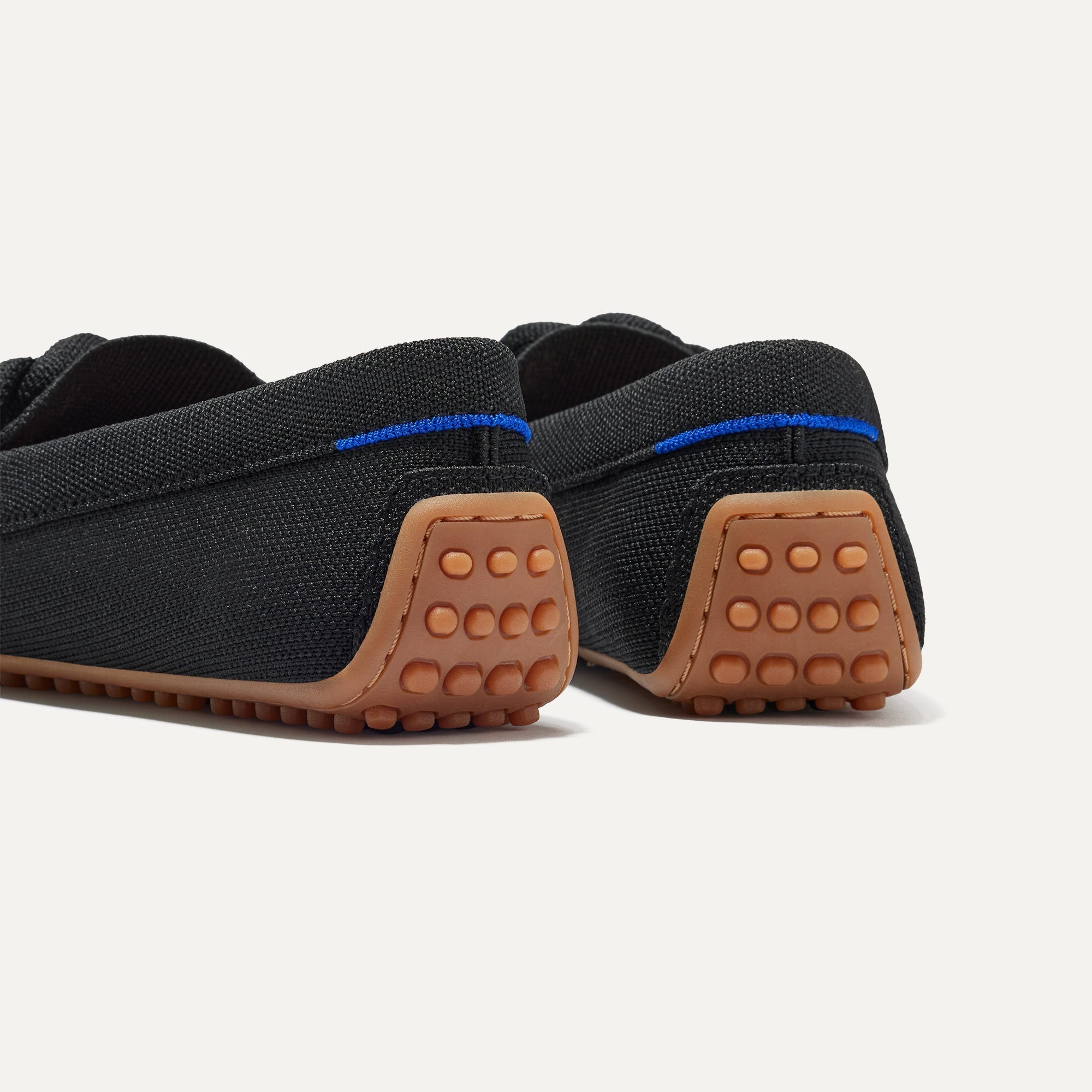 Close up of the heel of The Braid Driver in Black, with Rothy's signature blue halo. 