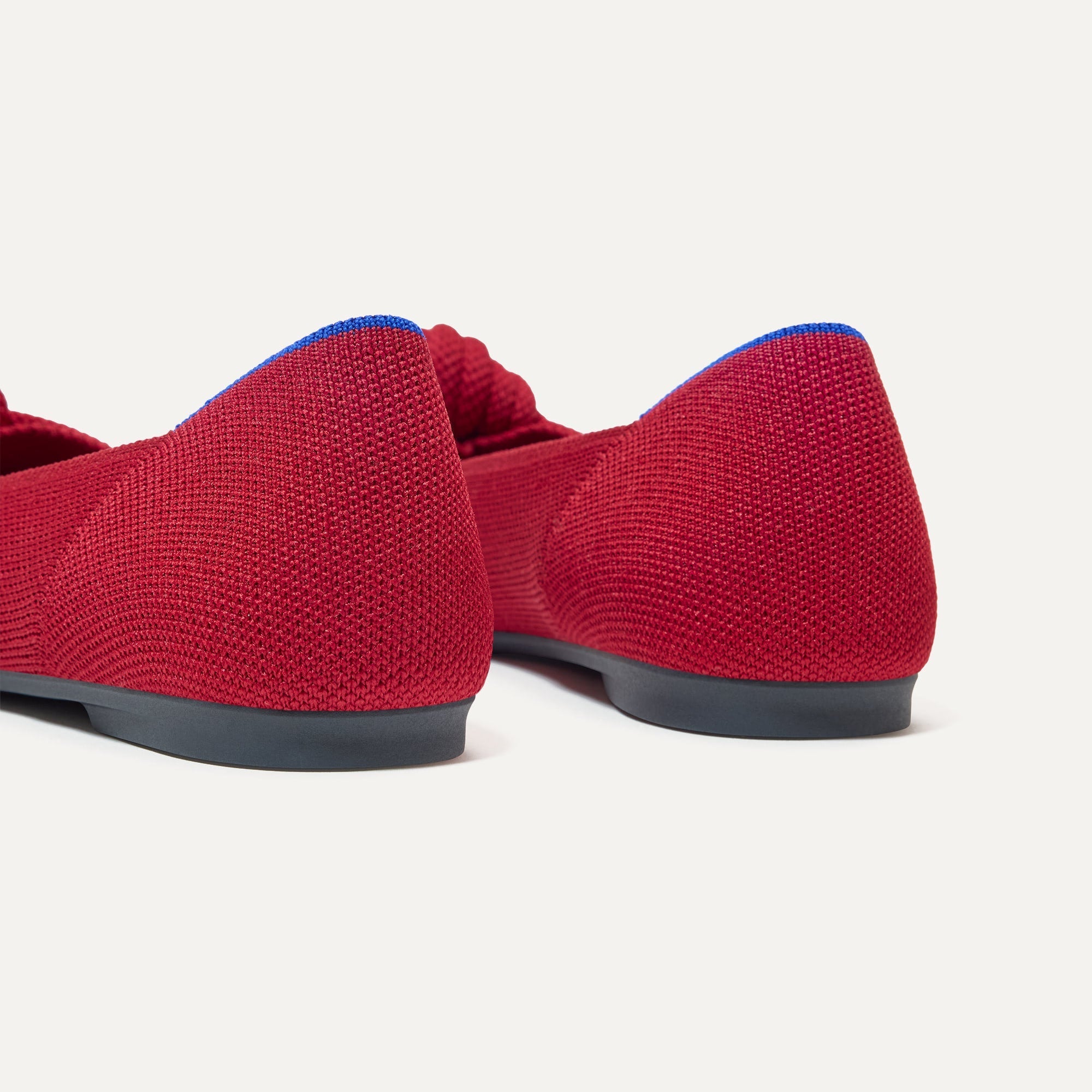 Close up of the heel of The Knot Point II in Candied Berry, with Rothy's signature blue halo. 