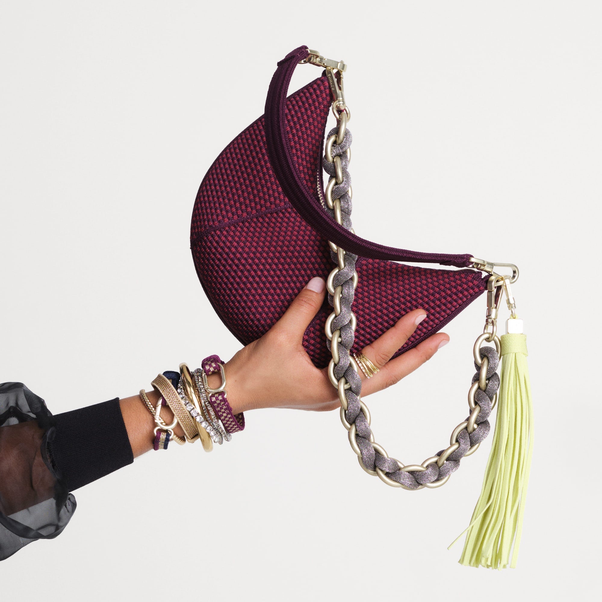 The Shoulder Strap in Golden Silver Chain paired with The Mini Crescent Bag and The Tassel Clip.