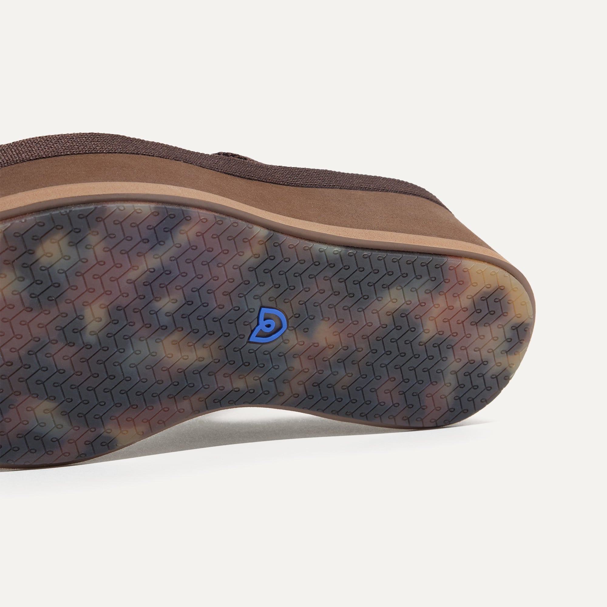 Close up of the outsole of The Lightweight Wedge Sandal in Cardamom, shown in a diagonal view. 